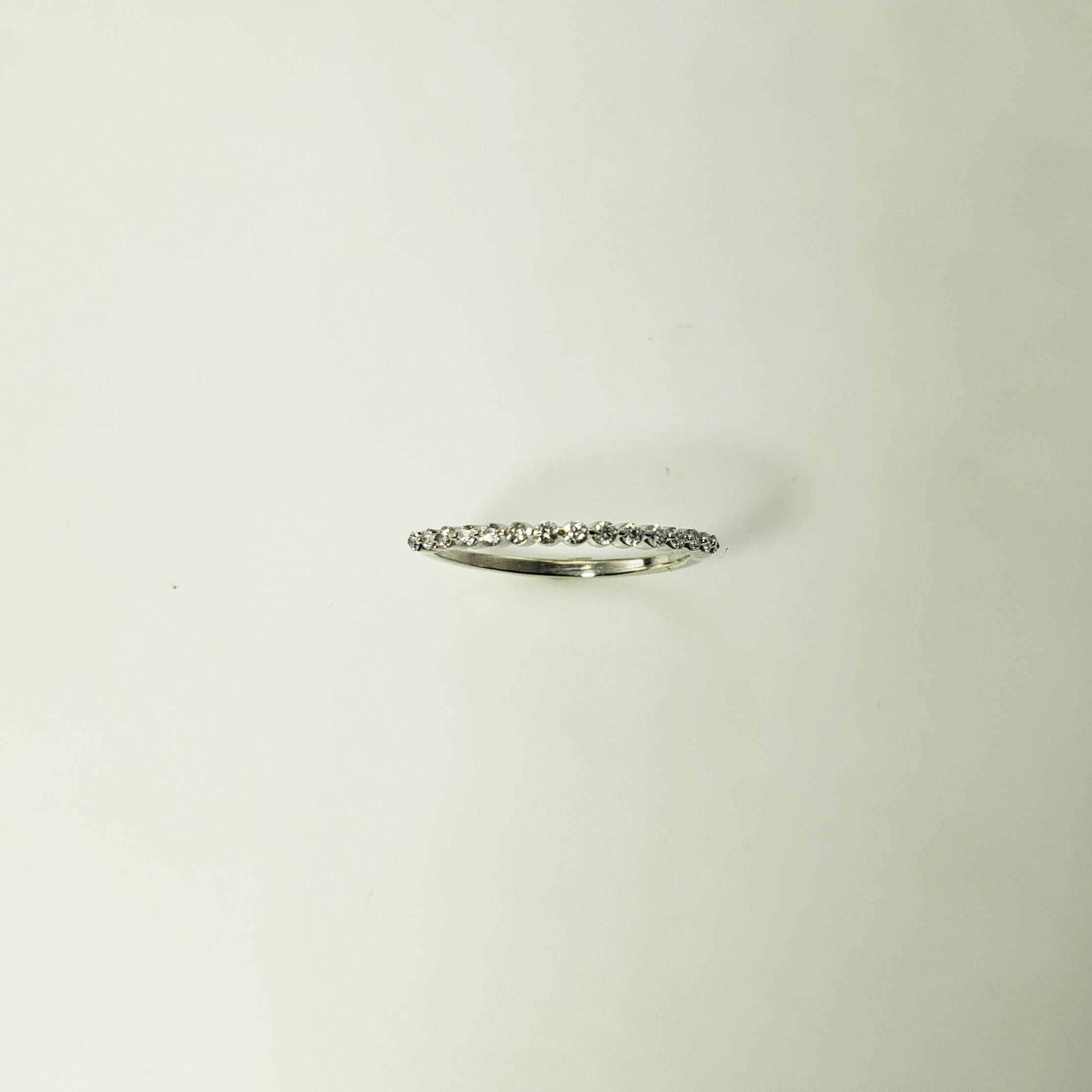 This sparkling band features 15 round brilliant cut diamonds set in classic 10K white gold.  Width:  1.5 mm.

Approximate total diamond weight:  .15 ct.

Diamond color: I

Diamond clarity: SI1

Size:  5.25

Weight: 0.4  dwt. /  0.7 gr.

Tested 10K