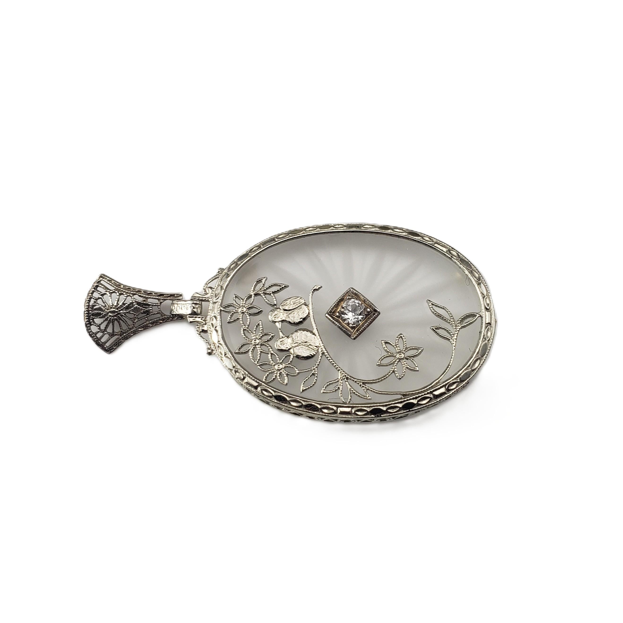 10 Karat White Gold Camphor Glass Lovebirds Pendant-

This lovely camphor glass pendant is a timeless piece that embodies romance, elegance and intricate craftsmanship. The romantic lovebirds and flowers are crafted in beautifully detailed 10K white