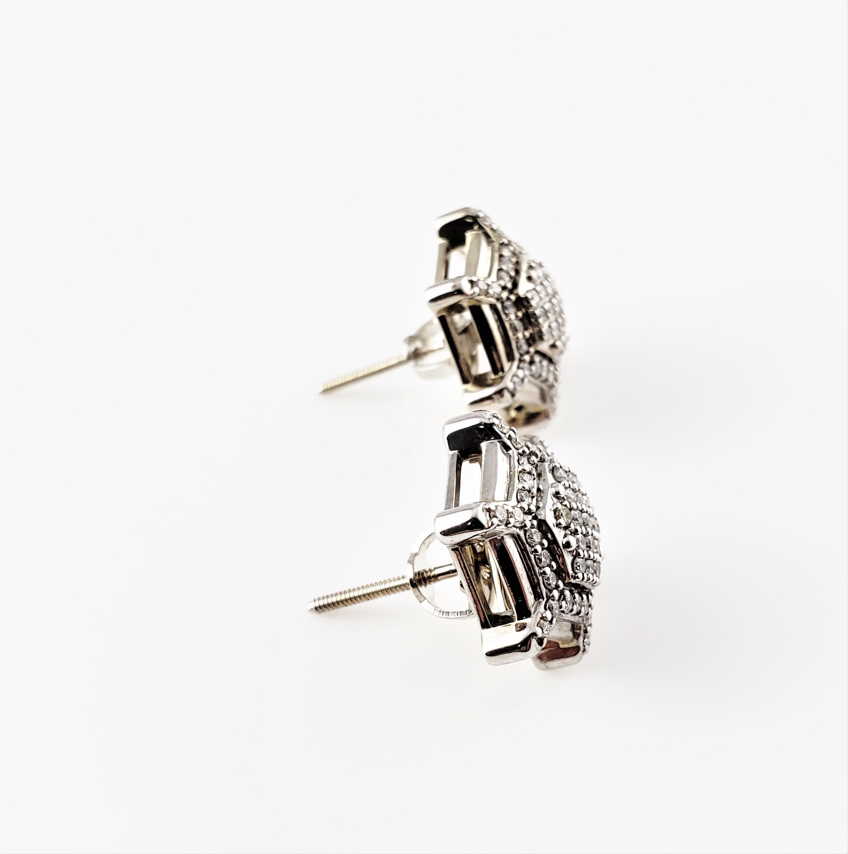 Vintage 10 Karat White Gold and Diamond Earrings-

These sparkling earrings each feature 47 round brilliant cut diamonds set in elegant 10K white gold. Push back closures.

Approximate total diamond weight: .94 ct.

Diamond color: G-H

Diamond