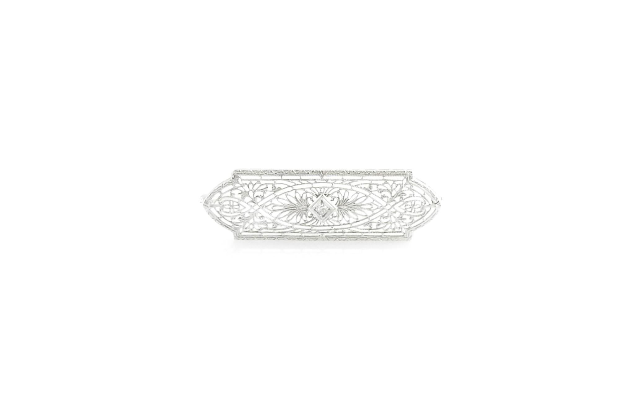 Vintage 10 Karat White Gold and Diamond Filigree Brooch / Pin

This stunning brooch features one round single cut diamond set in beautifully detailed 10K white gold filigree.

Approximate total diamond weight: .03 ct.

Diamond color: H

Diamond