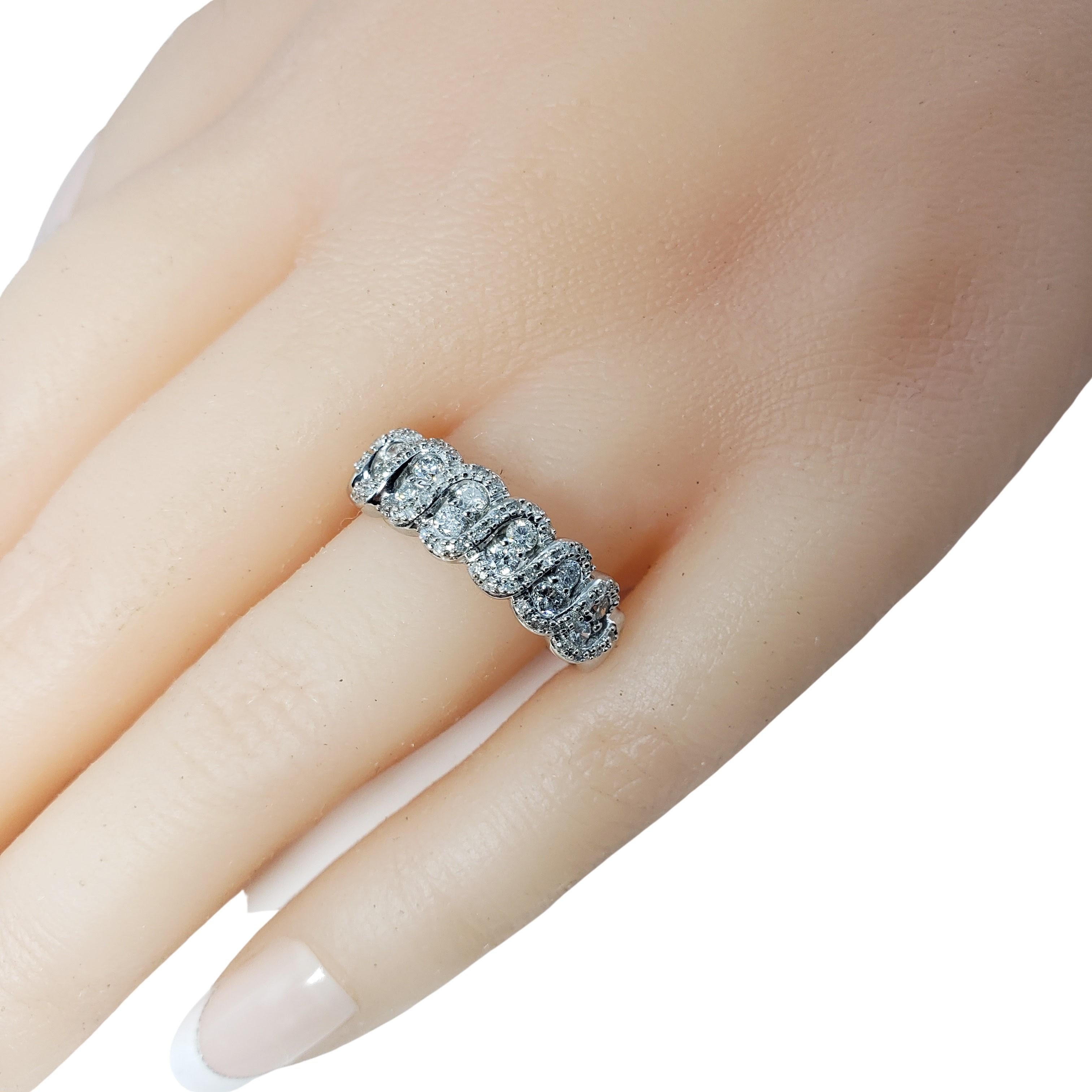 Vintage 10 Karat White Gold and Diamond Ring Size 8.25-

This sparkling ring features 12 round brilliant cut diamonds and 48 round single cut diamonds set in classic 10K white gold.
Width: 7 mm. Shank: 2 mm.

Approximate total diamond weight: .68