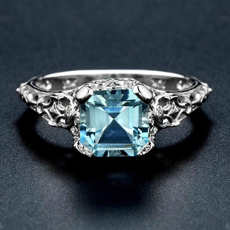 Filigree Style Cocktail Ring set with Step Cut Blue Topaz 2.10 Carat. 

This Ring was made in 10K White Gold size US#6


