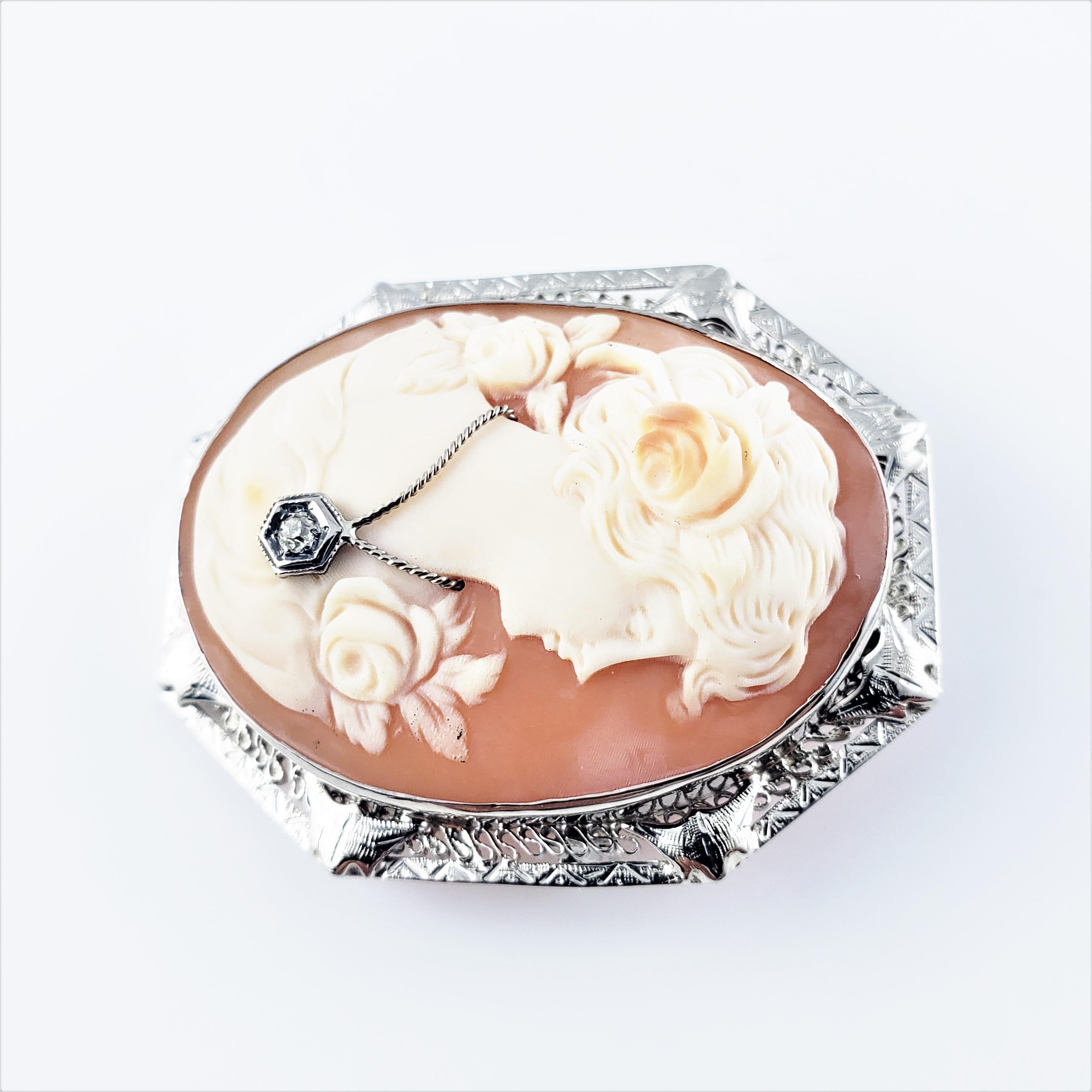 10 Karat White Gold Cameo Brooch/Pendant-

This stunning cameo features a lovely lady in profile framed in beautifully detailed 10K white gold filigree.  Accented with one round single cut diamond.  Can be worn as a brooch or a pendant.

*Chain not