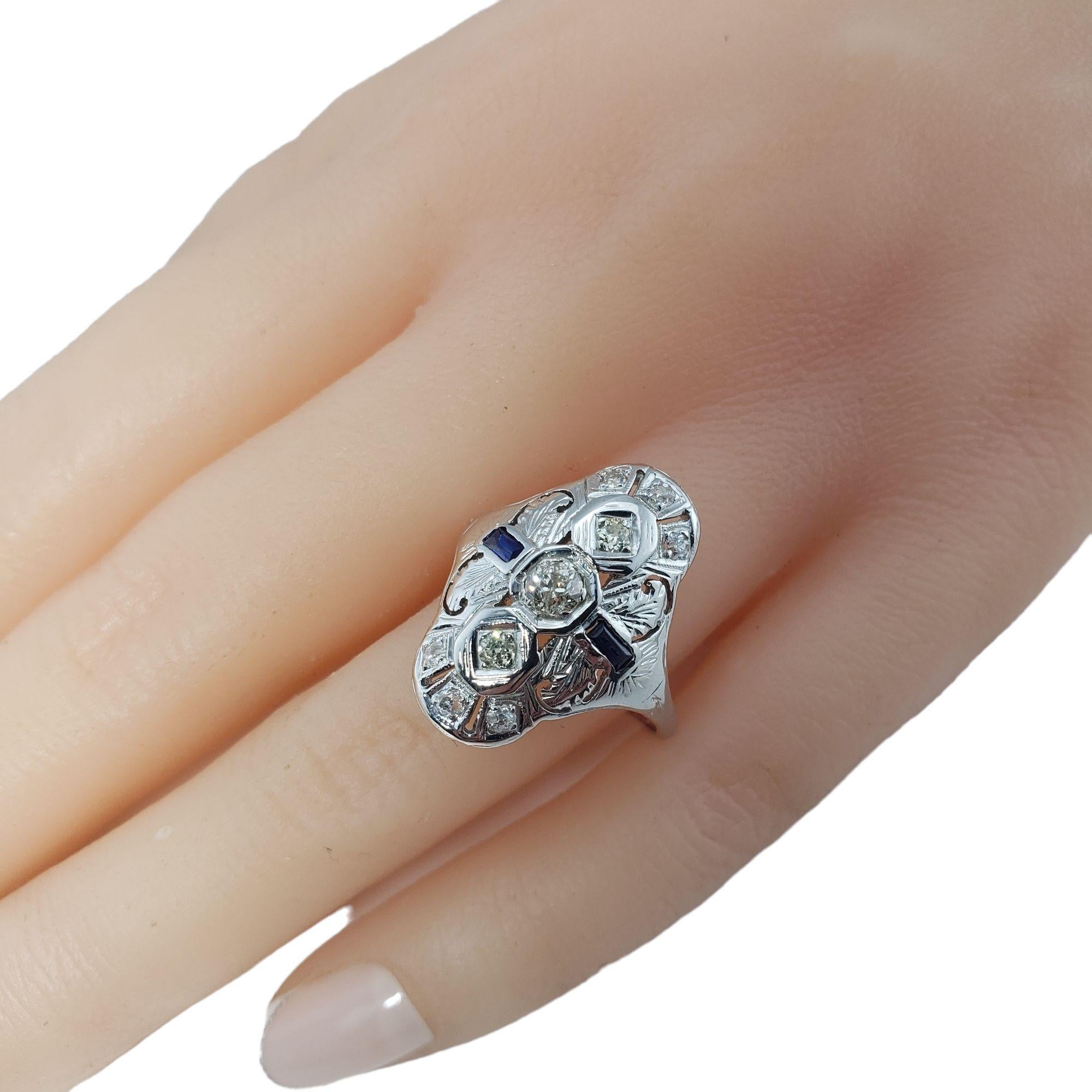 Vintage 10 Karat White Gold Diamond and Lab Created Sapphire Ring Size 8.5-

This stunning ring features nine European cut diamonds and two lab created sapphires set in beautifully detailed 10K white gold filigree.  
Width:  21 mm.  Shank: 1