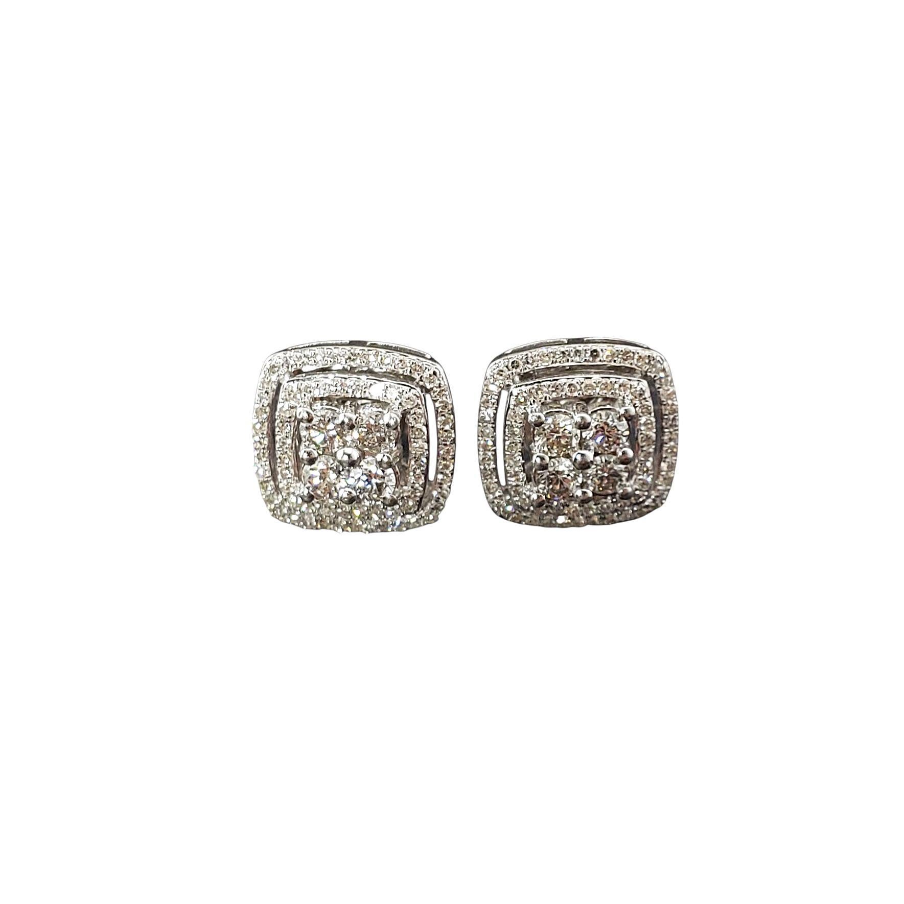 10 Karat White Gold Diamond Cluster Earrings-

These dazzling 10K white gold earrings showcase an elegant cushion-shaped cluster design, each encrusted with 70 round sparkling diamonds. The layered pave halos and central diamond clusters create a