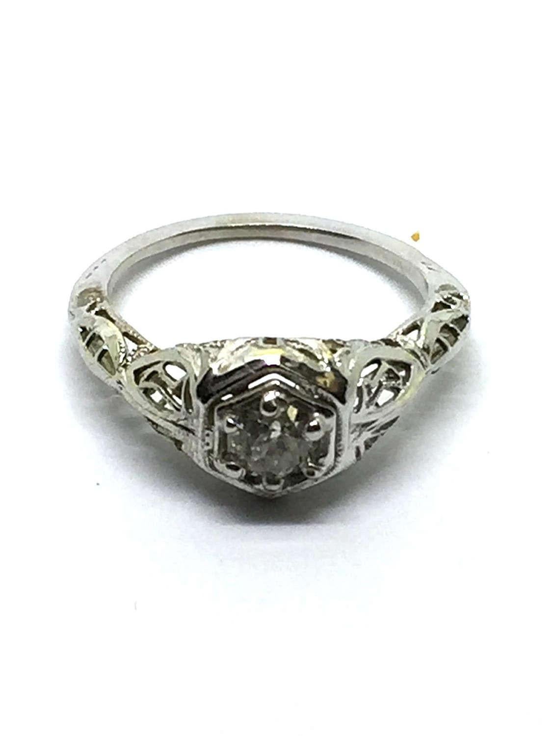 Vintage 10 Karat White Gold Diamond Engagement Ring 

This classic engagement ring features a sparkling old mine cut diamond set in exquisite white gold filigree. Approximate diamond weight: .45 ct. Diamond color: K Diamond clarity: VS2 

Ring Size: