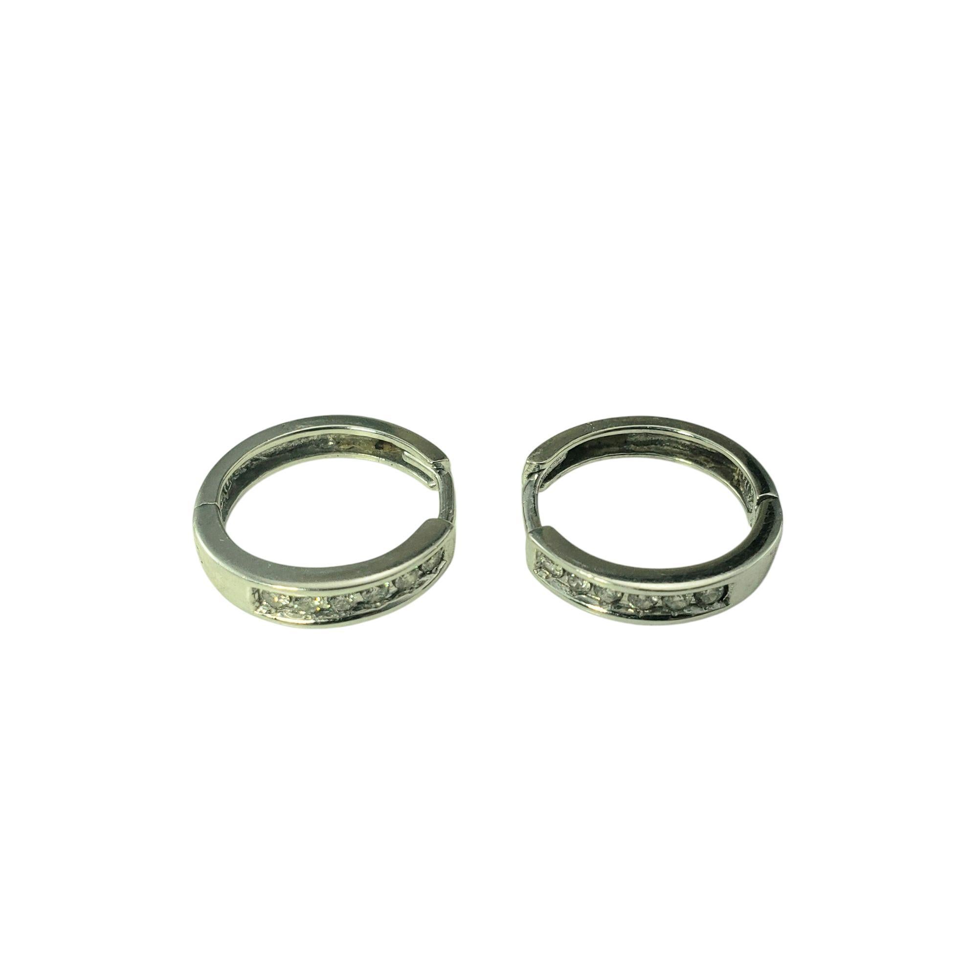 10 Karat White Gold Diamond Hoop Earrings-

These sparkling hoop earrings each feature six round brilliant cut diamonds set in classic 10K white gold. 

Width: 3 mm.

Approximate total diamond weight: .36 ct.

Diamond color: I

Diamond clarity: