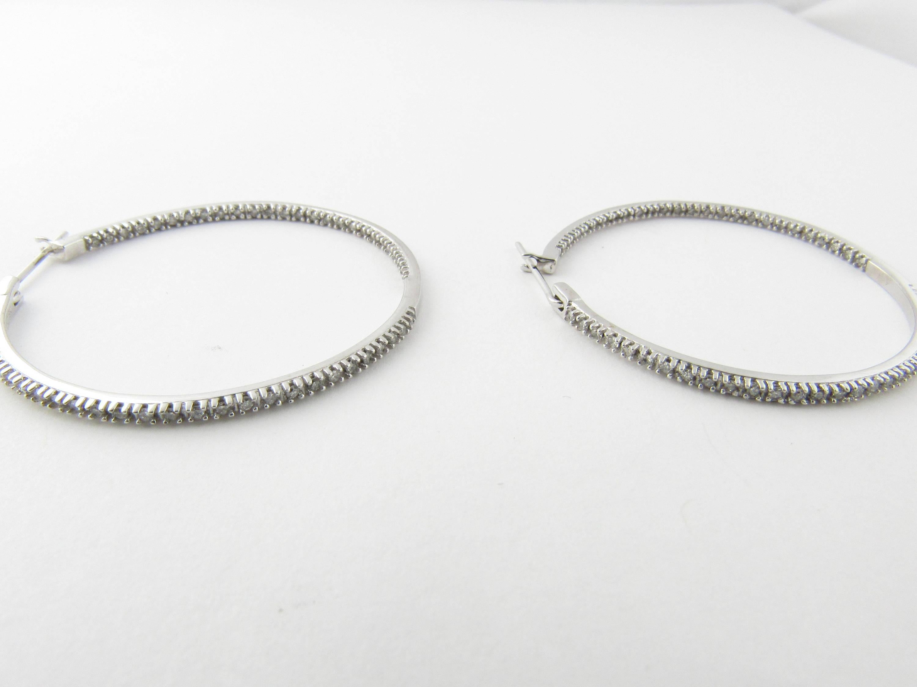 Vintage 10 Karat White Gold Diamond Hoop Earrings-

These sparkling hoop earrings feature 55 round brilliant single cut diamonds in each (29 in the front and 26 in the back) set in 10K white gold. 

Approximate total diamond weight: 1.10