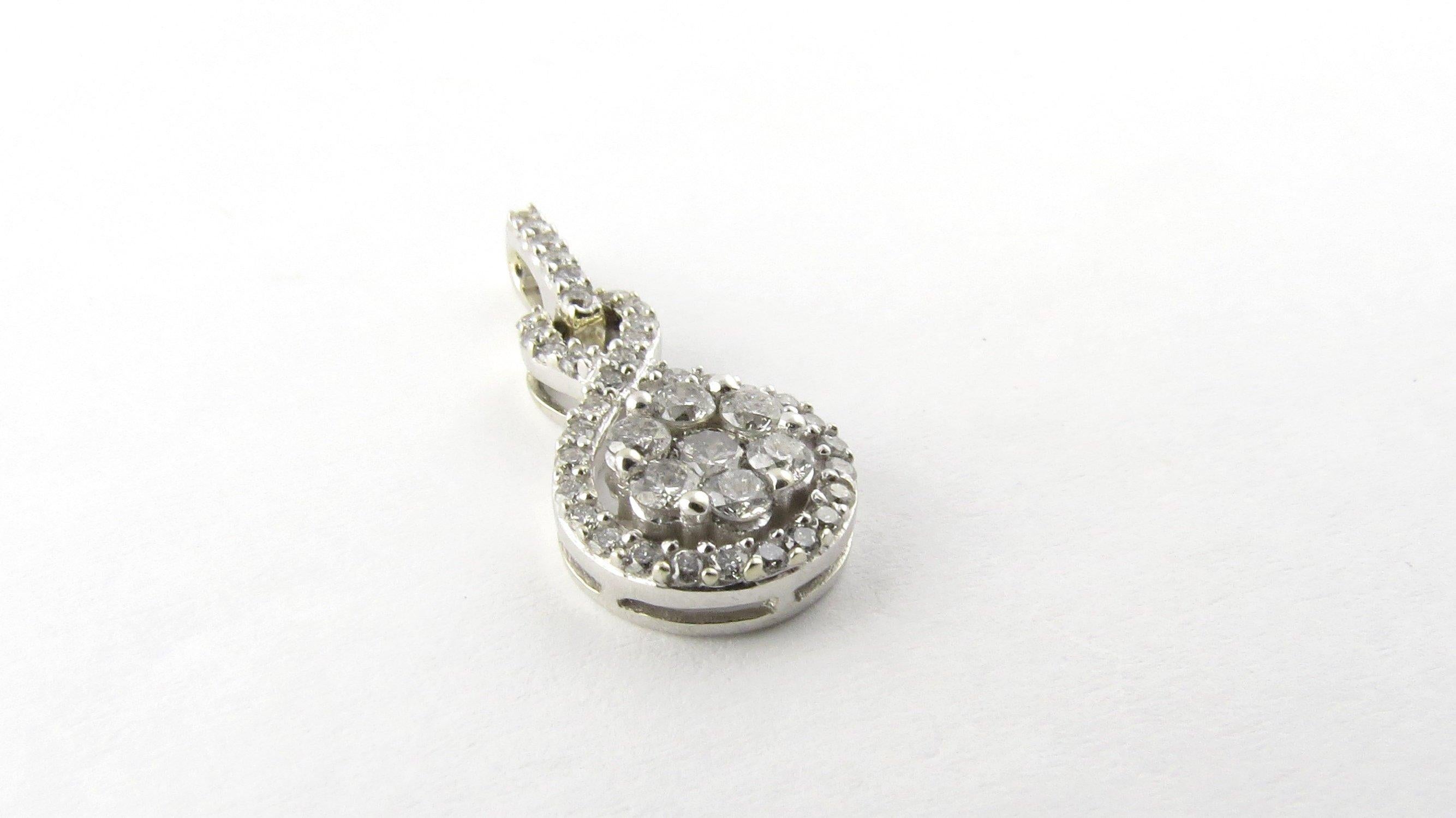 Vintage 10 Karat White Gold Diamond Pendant- 
This sparkling pendant features 42 round brilliant cut diamonds set in classic 10K white gold. 
Approximate total diamond weight: .58 ct. 
Diamond color: I 
Diamond clarity: I1-I2 
Size: 22 mm x 10 mm