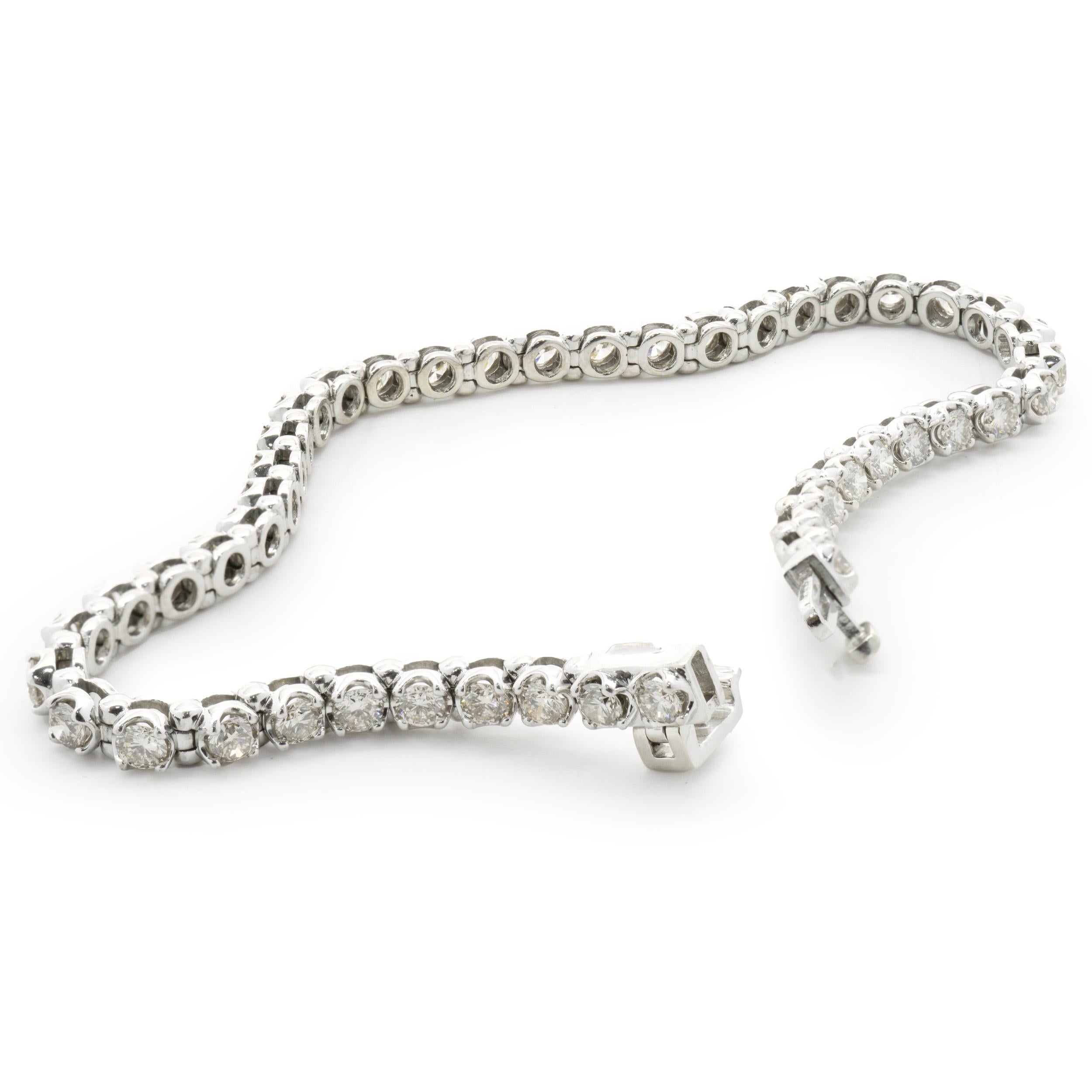 Designer: custom design
Material: 10K white gold
Diamonds: 46 round brilliant cu t= 3.68cttw
Color: J
Clarity: SI2
Dimensions: bracelet will fit up to a 6.75-inch wrist 
Weight: 10.80 grams