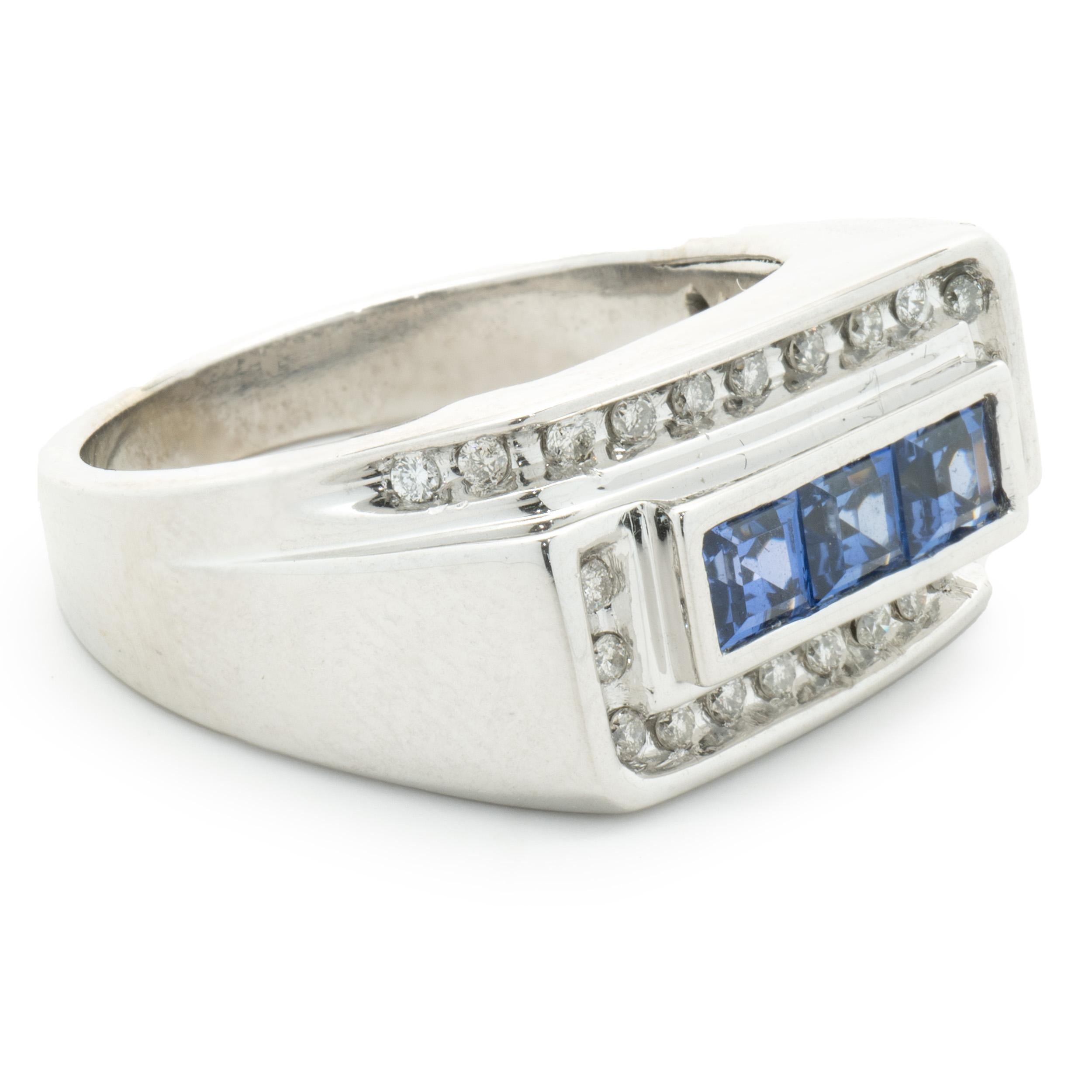 Designer: custom design
Material: 10K white gold
Diamond: 24 round cut = .24cttw
Color: I
Clarity: SI2
Sapphire: 3 princess cut = 0.90cttw
Dimensions: ring top measures 11mm wide
Ring Size: 9.5 (please allow two extra shipping days for sizing