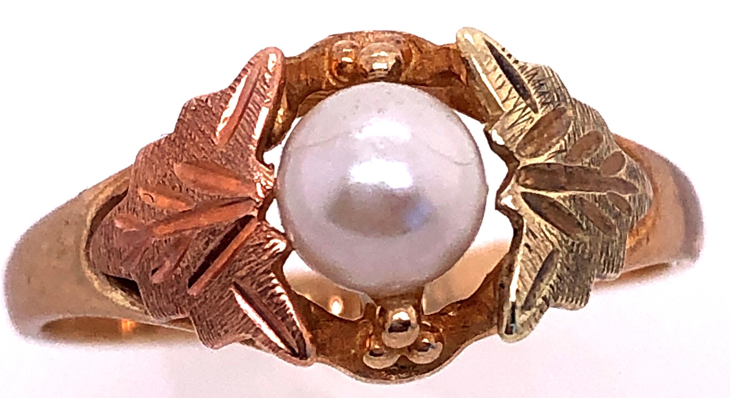 10 Karat Yellow and Rose Gold Fashion Pearl Ring Size 7.75.
5 mm diameter pearl.
1.4 grams total weight.
