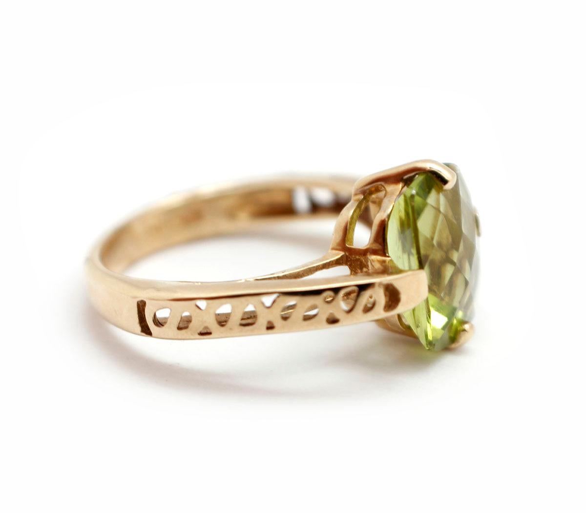 This beautiful cocktail ring is made in 10k yellow gold. The ring holds a peridot measuring 7x9mm wide. The ring weighs 2.20 grams, and it is size 3.25.