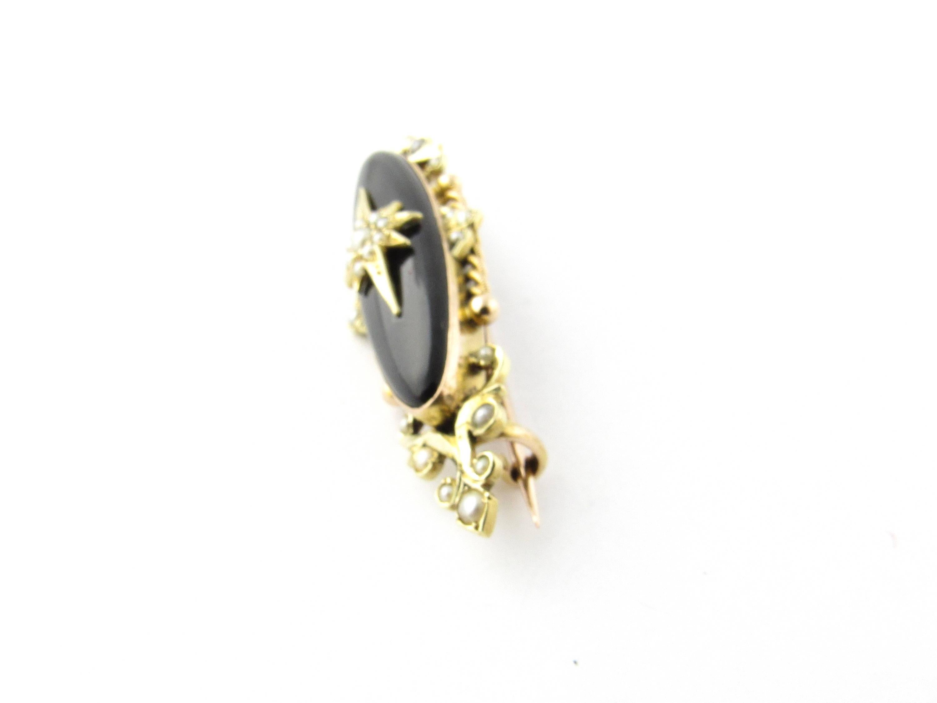 Vintage 10 Karat Yellow Gold Black Onyx and Pearl Brooch- 
This elegant brooch features an oval black onyx stone accented with 29 seed pearls - set in beautifully detailed yellow gold. 
Size:  48 mm x  14 mm 
Weight:  4.2 dwt. /  6.6 gr. 
Hallmark:
