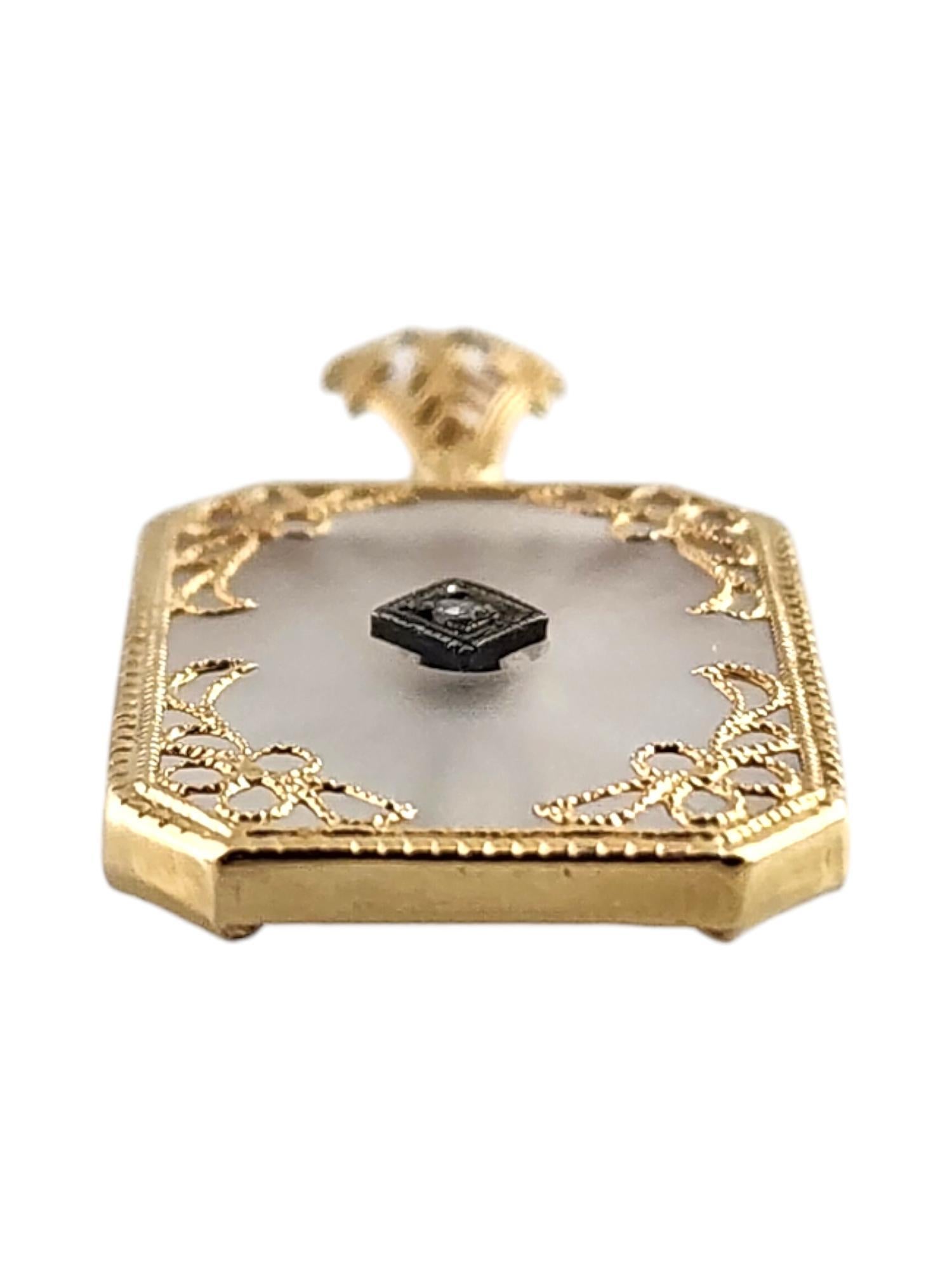 10 Karat Yellow Gold Camphor Glass and Diamond Pendant-

This beautiful pendant features camphor glass encased in a 10K yellow gold filigree frame. The center of the pendant is decorated with one round single cut diamond.

Approximate total diamond