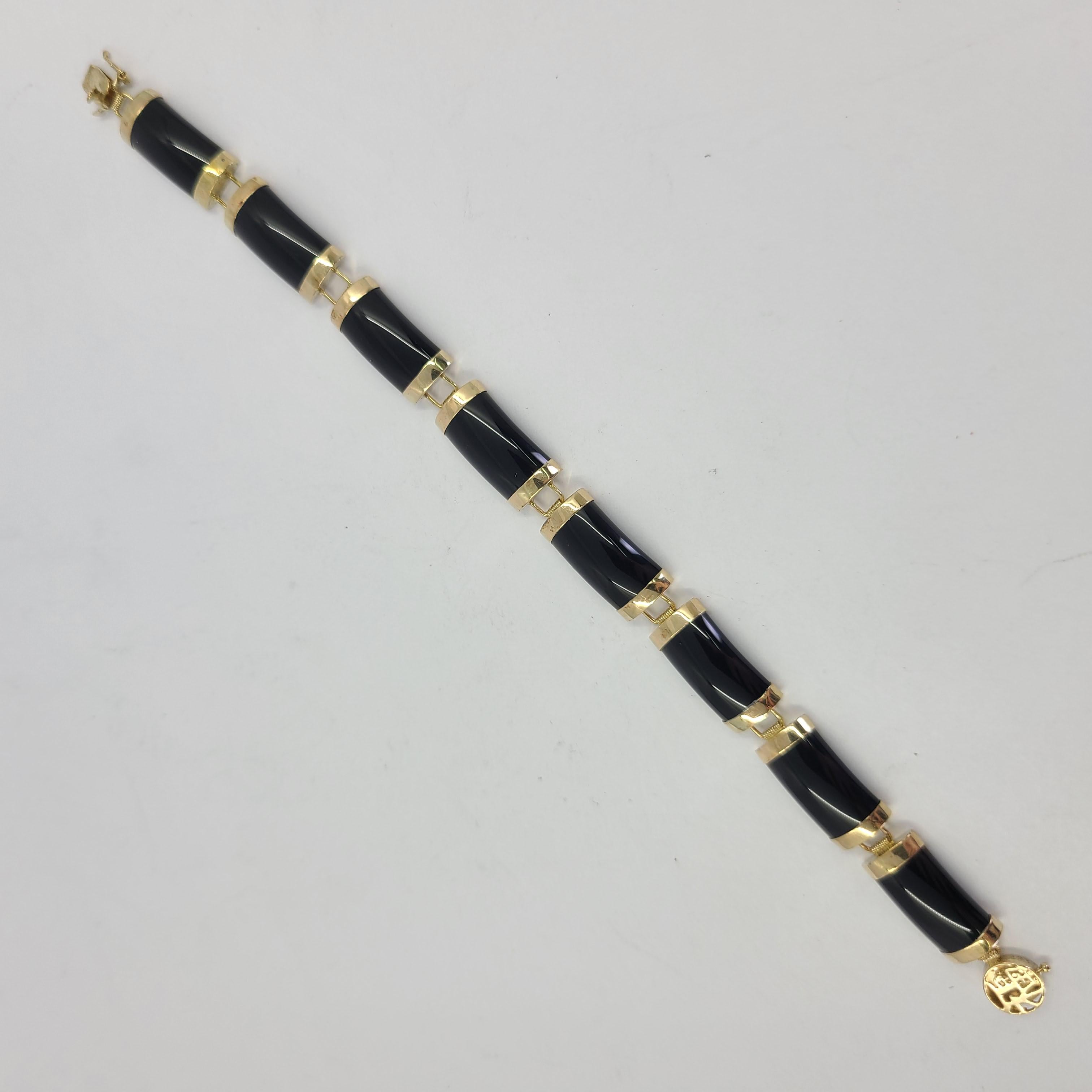 10 Karat Yellow Gold & Onyx Bracelet Measuring 6 Inches Long. Asian Symbol On Clasp With Figure 8 Safety. Finished Weight Is 9.0 Grams. 