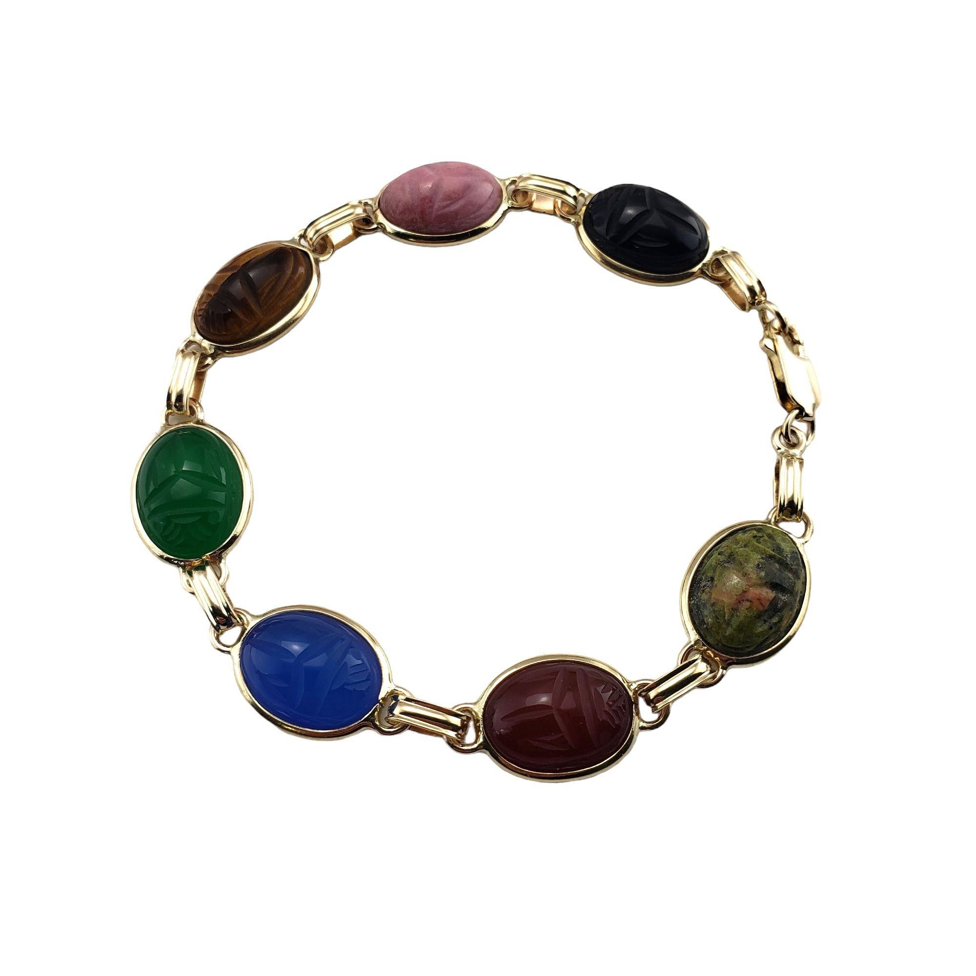 Vintage 10 Karat Yellow Gold Scarab Bracelet-

This lovely scarab bracelet features seven multicolored gemstones (13 mm x 8 mm) set in classic 10K yellow gold. Width: 11 mm.

Size: 7.5 inches

Weight: 7.8 dwt. / 12.1 gr.

Stamped: 10K

Very good