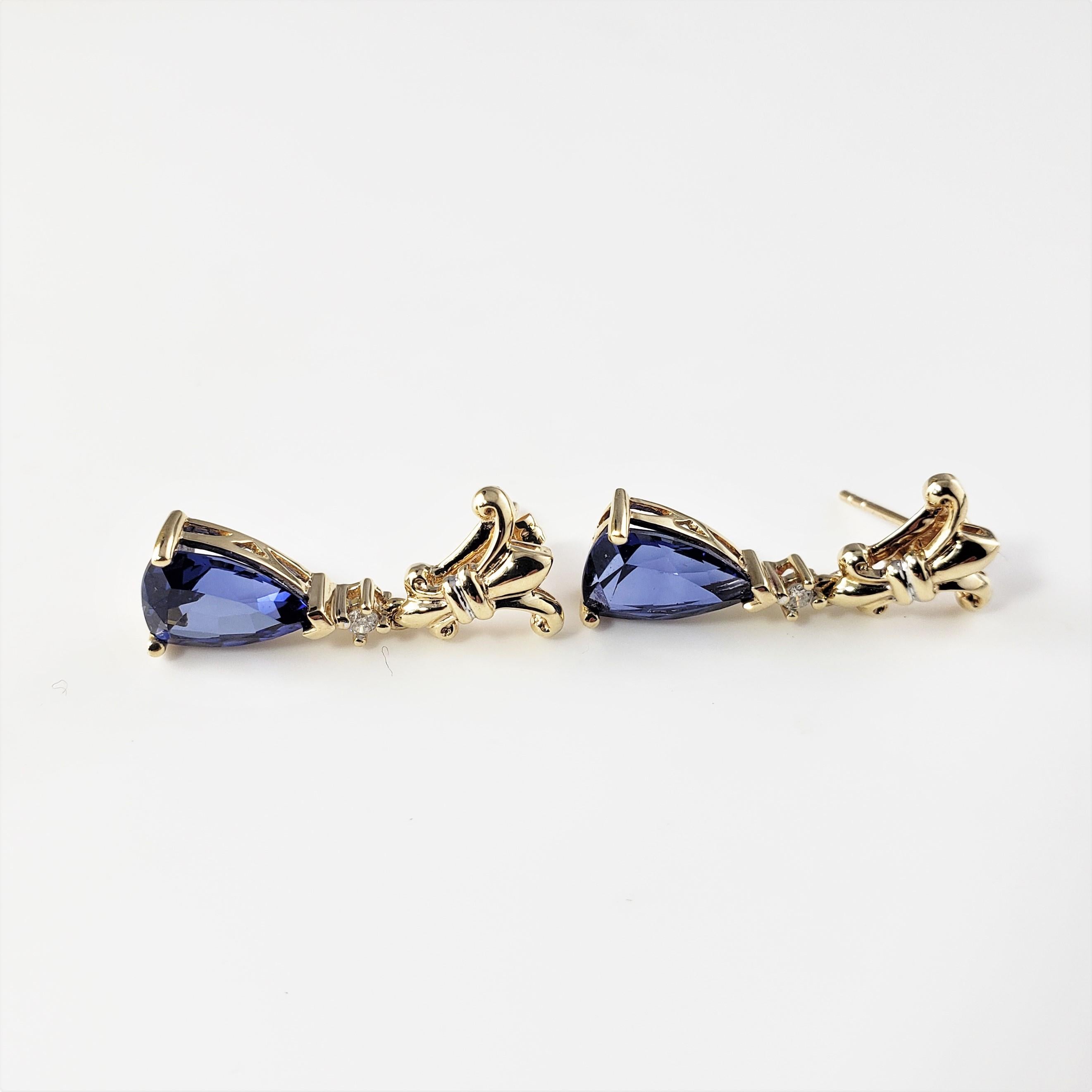 10 Karat Yellow Gold Tanzanite and Diamond Earrings-

These elegant dangling earrings each feature one pear shaped tanzanite (10 mm x 8 mm) and one round brilliant cut diamond set in beautifully detailed 10K yellow gold.

Total tanzanite weight: 