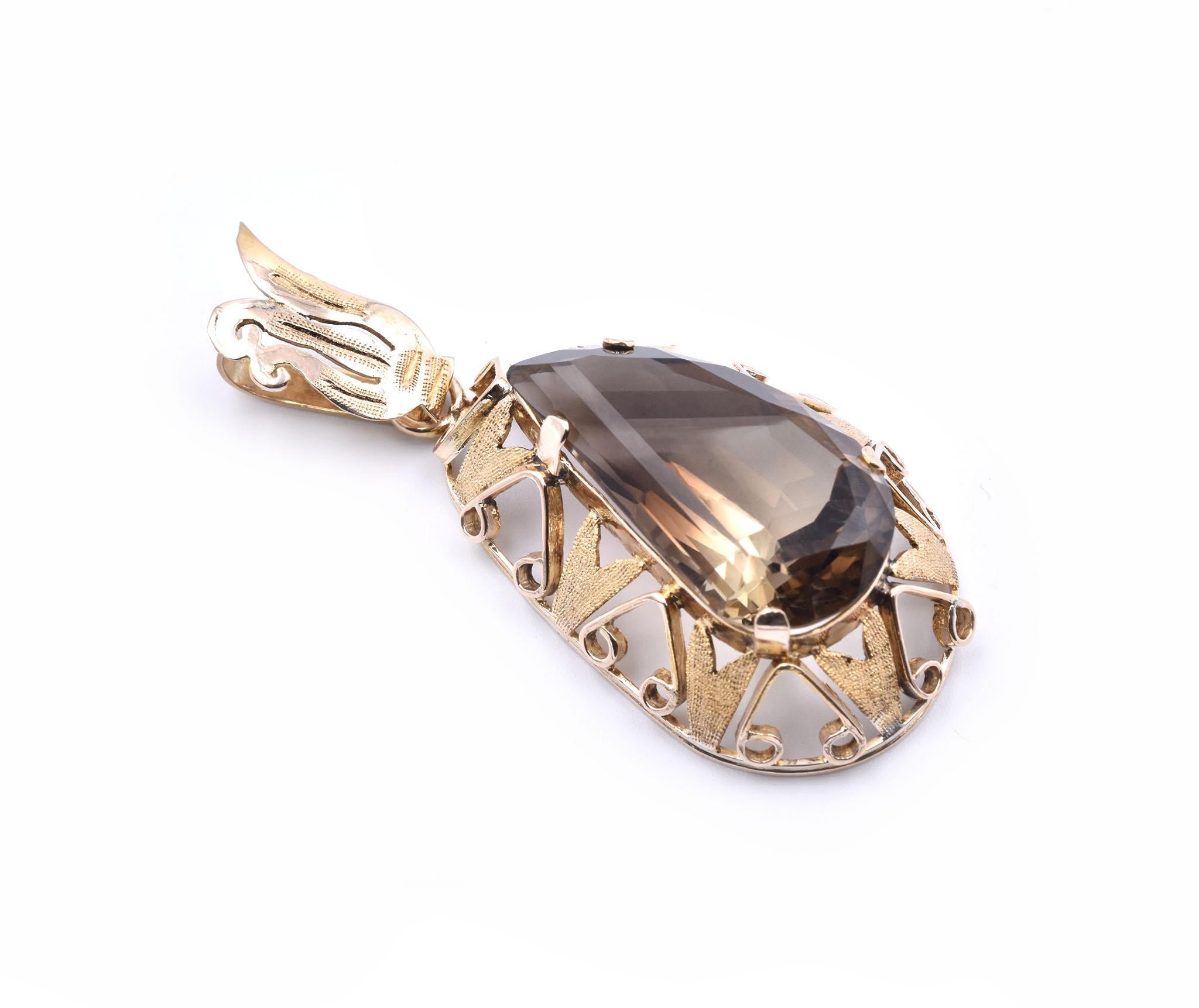 Designer: custom
Material: 10K yellow gold
Smoky Topaz: 1 pear cut = 32.97ct
Dimensions: the pendant measures 61.75mm x 26.18mm 
Weight: 13.03 grams