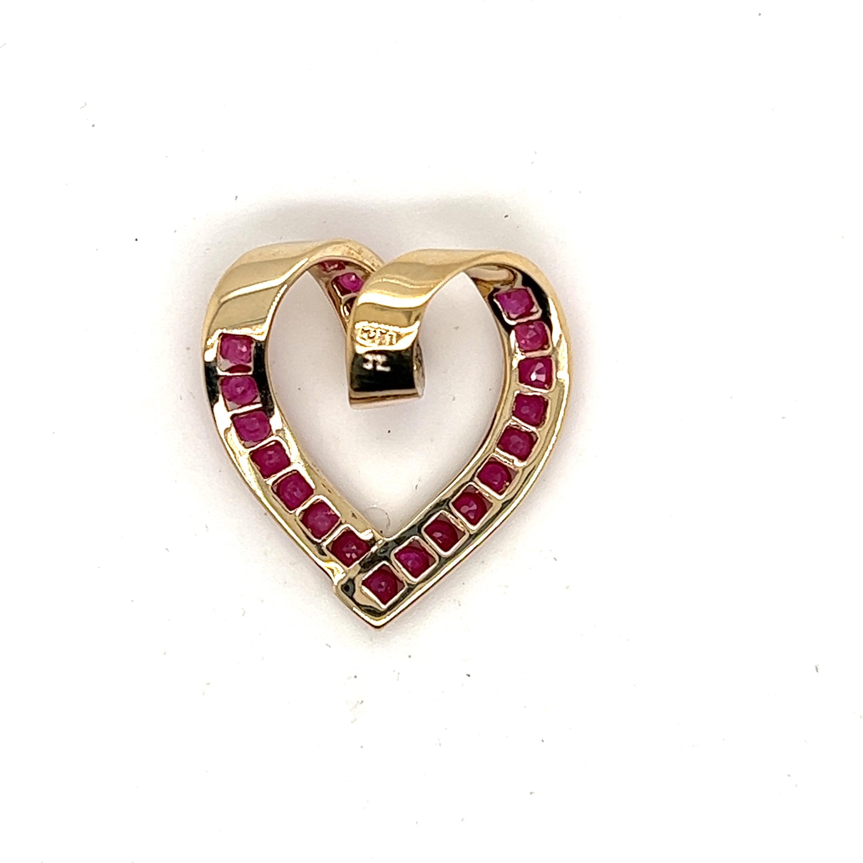 10kt yellow gold heart pendant slide set with 22 channel set round brilliant cut Rubies that total approximately .88 carats. 

The heart measures 15/16 inches long and 7/8 inch wide.
