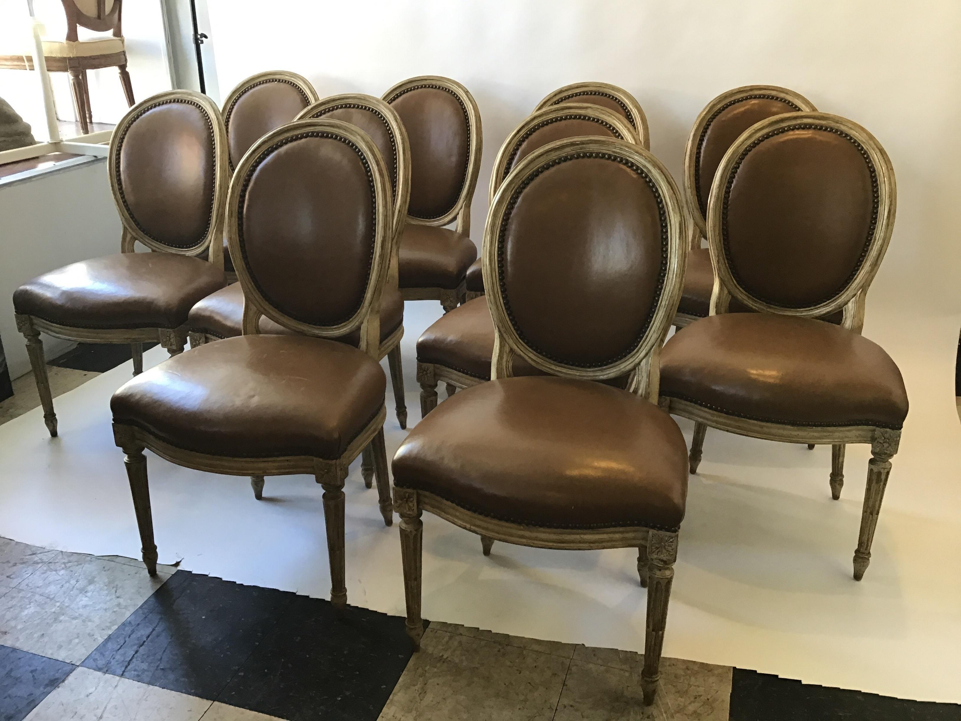 10 1950s leather Louis XVI 1950s dining chairs from a Scarsdale, NY estate. One chair is ripped, as shown in image 16.