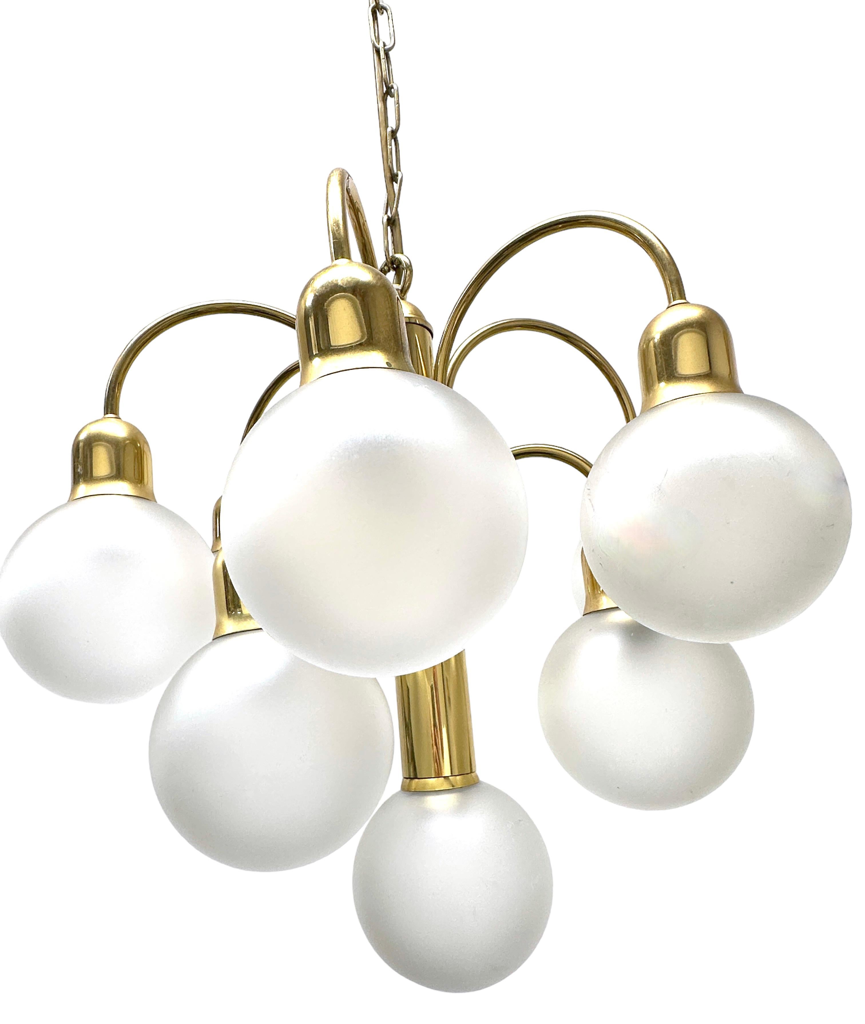 Very decorative and beautiful chandelier made of brass, fitted with ten E14 sockets with frosted glass ball shades. Vintage tiered chandelier made of gilt brass and frosted glass of exceptional beauty is perfect for installation on the ceiling of a