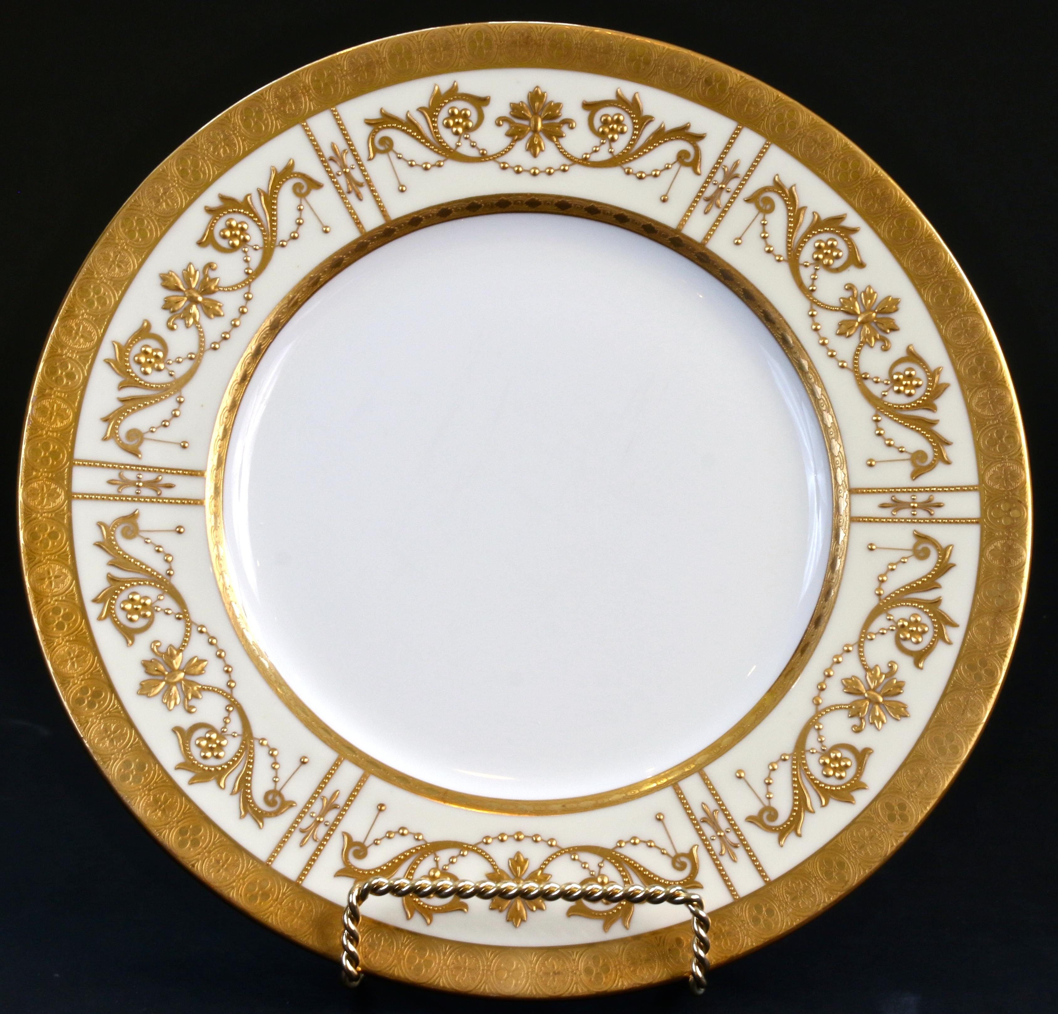 This elegant set of 19th century Minton, Stoke-on-Trent, England heavy raised paste 22-karat plates are for presentation or dinner. The plates have a white center with an ivory rim that is decorated with Adam-style beaded swags and scrolling