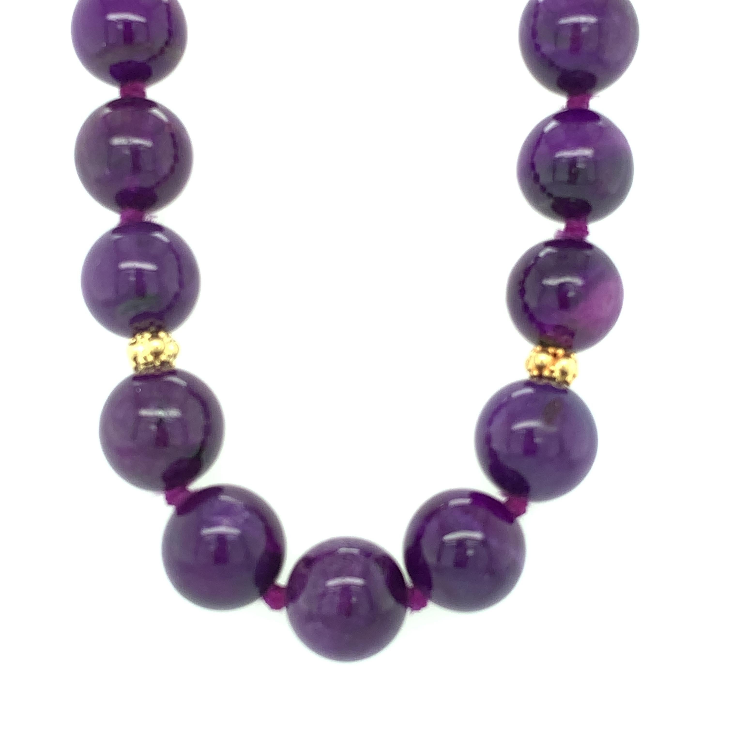 This striking necklace features 10.00mm beads fashioned from sugilite, a gorgeous, relatively rare mineral from South Africa that is prized for its intense purple color. These fine-quality beads are extremely well-matched, with rich, even purple
