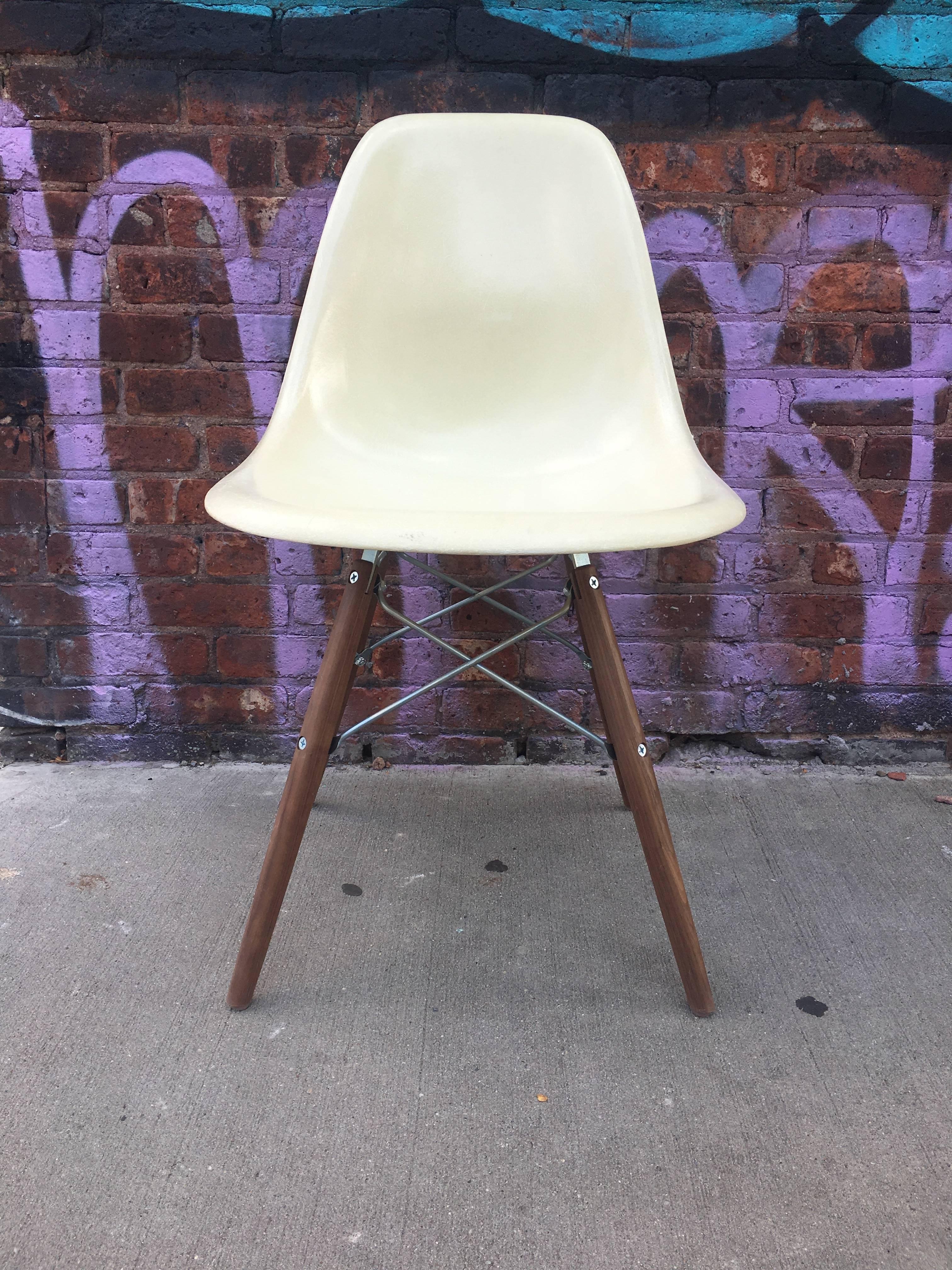 10 Herman Miller Eames multicolored dining chairs. Ships disassembled. Shells in good vintage condition with no holes or cracks. All signed Herman Miller. Shells may vary in color due to the volume. Photo of actual base in last photo. Stained walnut