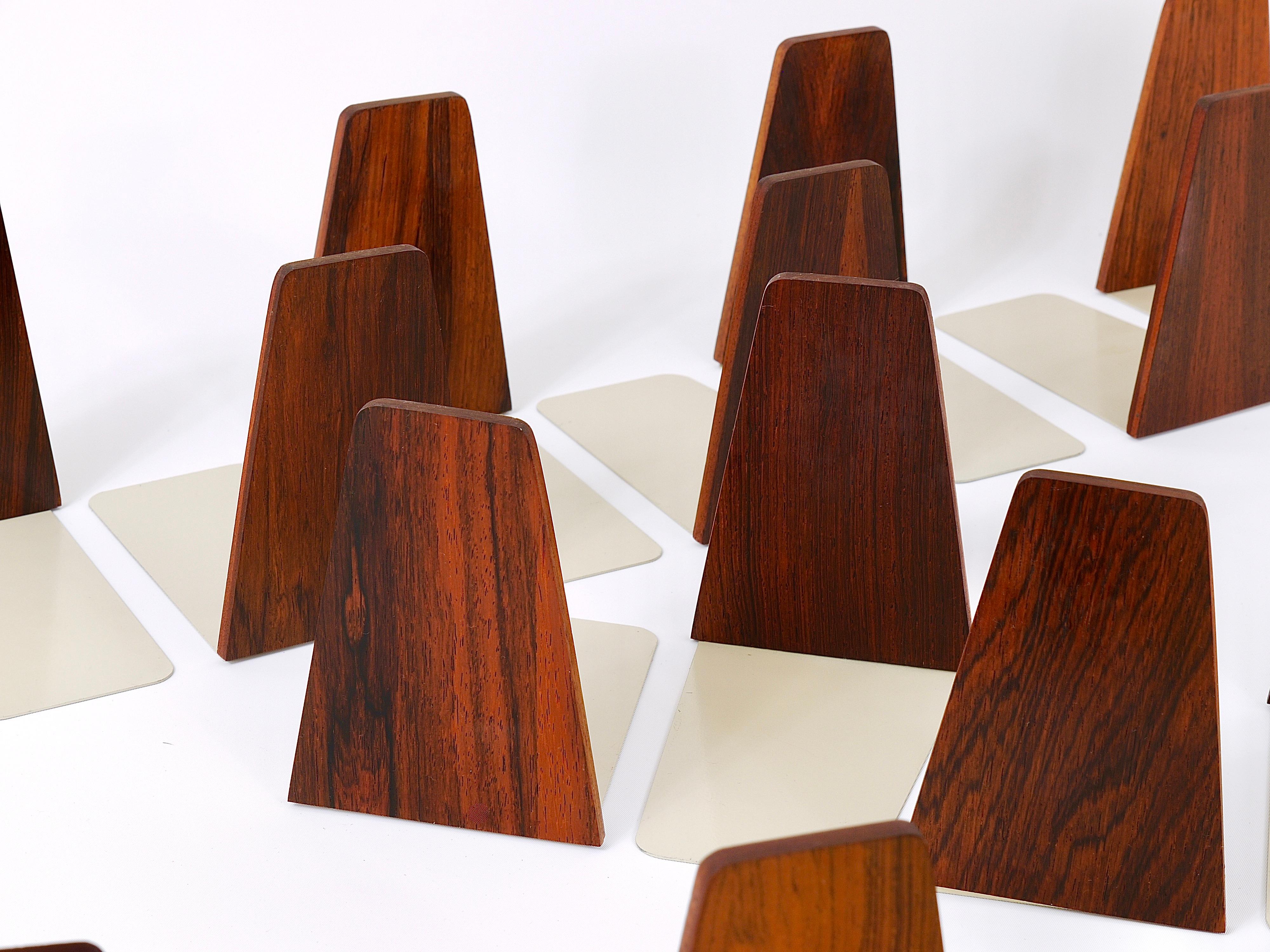 Up to five pairs of beautiful midcentury bookends, made in Denmark in the 1960s. Designed by Kai Kristiansen, executed by Fm Moebler, Made of lovely grained rose wood with grey lacquered metal bases. In very good condition, with marginal signs of