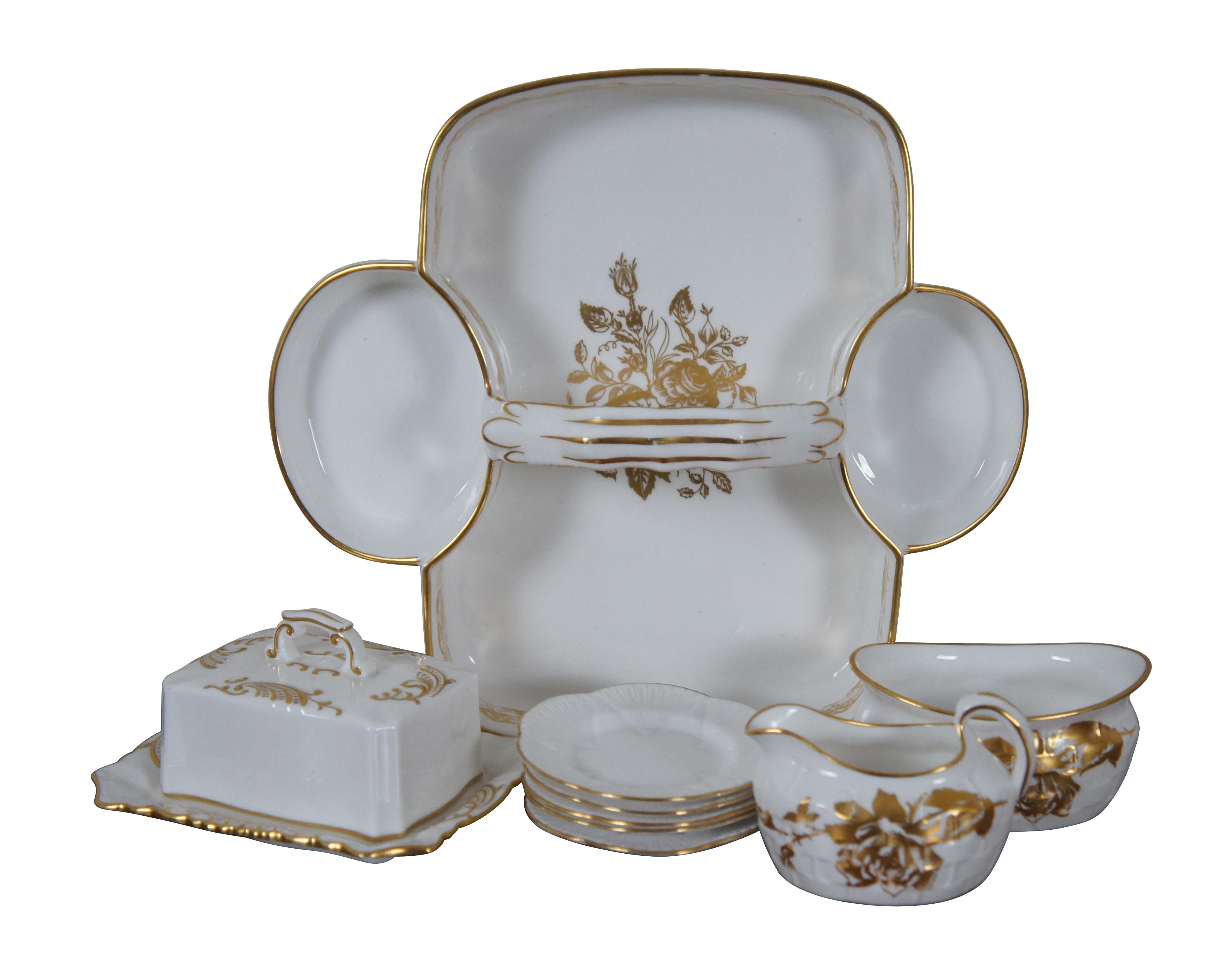 #38183

Vintage 10 piece serving set by Hammersley & Company. White bone china with gilded details. Set includes handled serving tray with creamer and sugar bowl in the Rose Point pattern, butter dish and lid, and five flower shaped nut dishes /