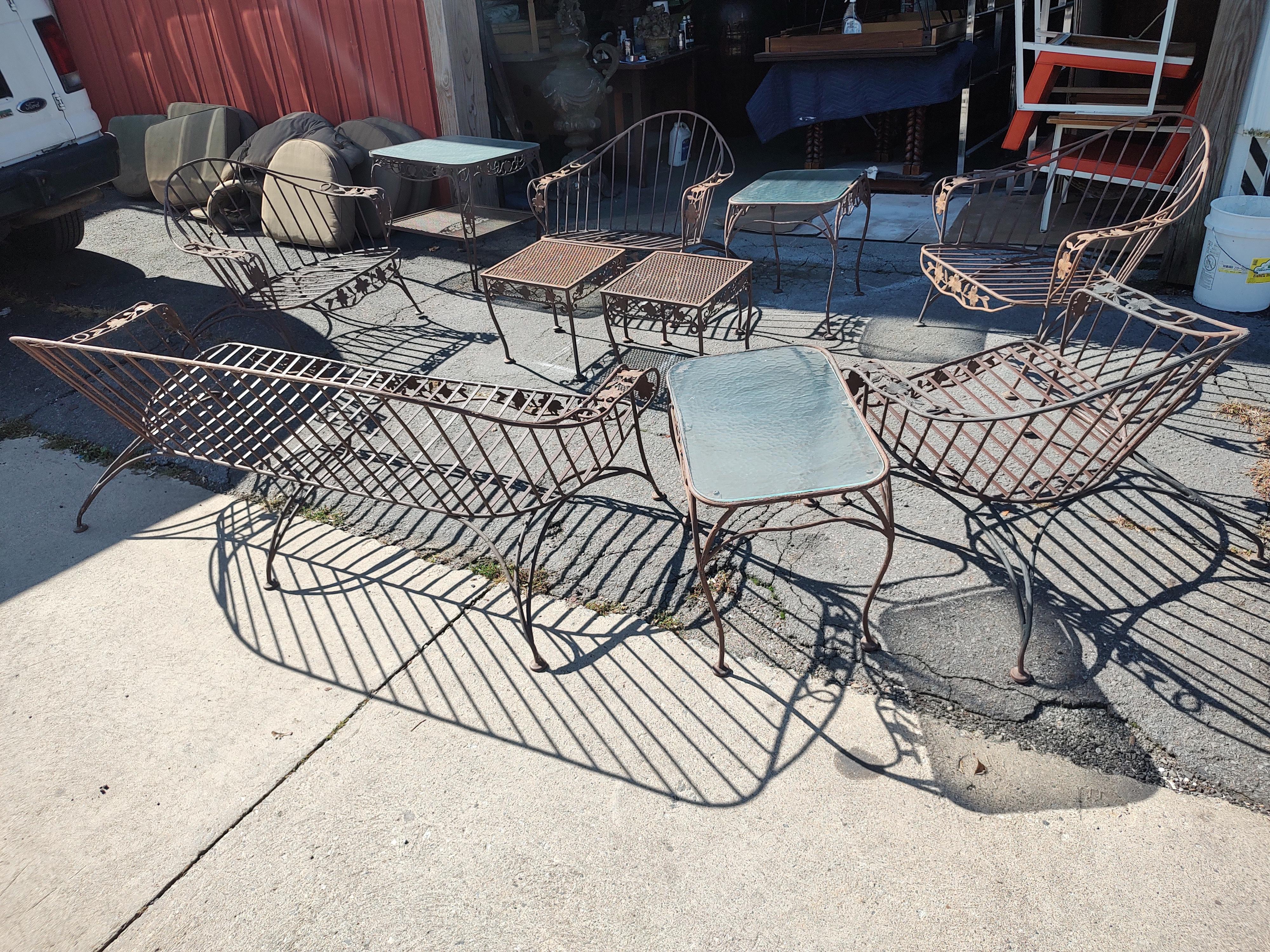 Rare and spectacular 10 pc set of extraordinary iron patio outdoor furniture by Russell Woodard c 1955. Sofa, 4 chairs and 5 tables 3 with obscure glass tops. Set has full cushions which may need replacement. I am going to wash a few and see how
