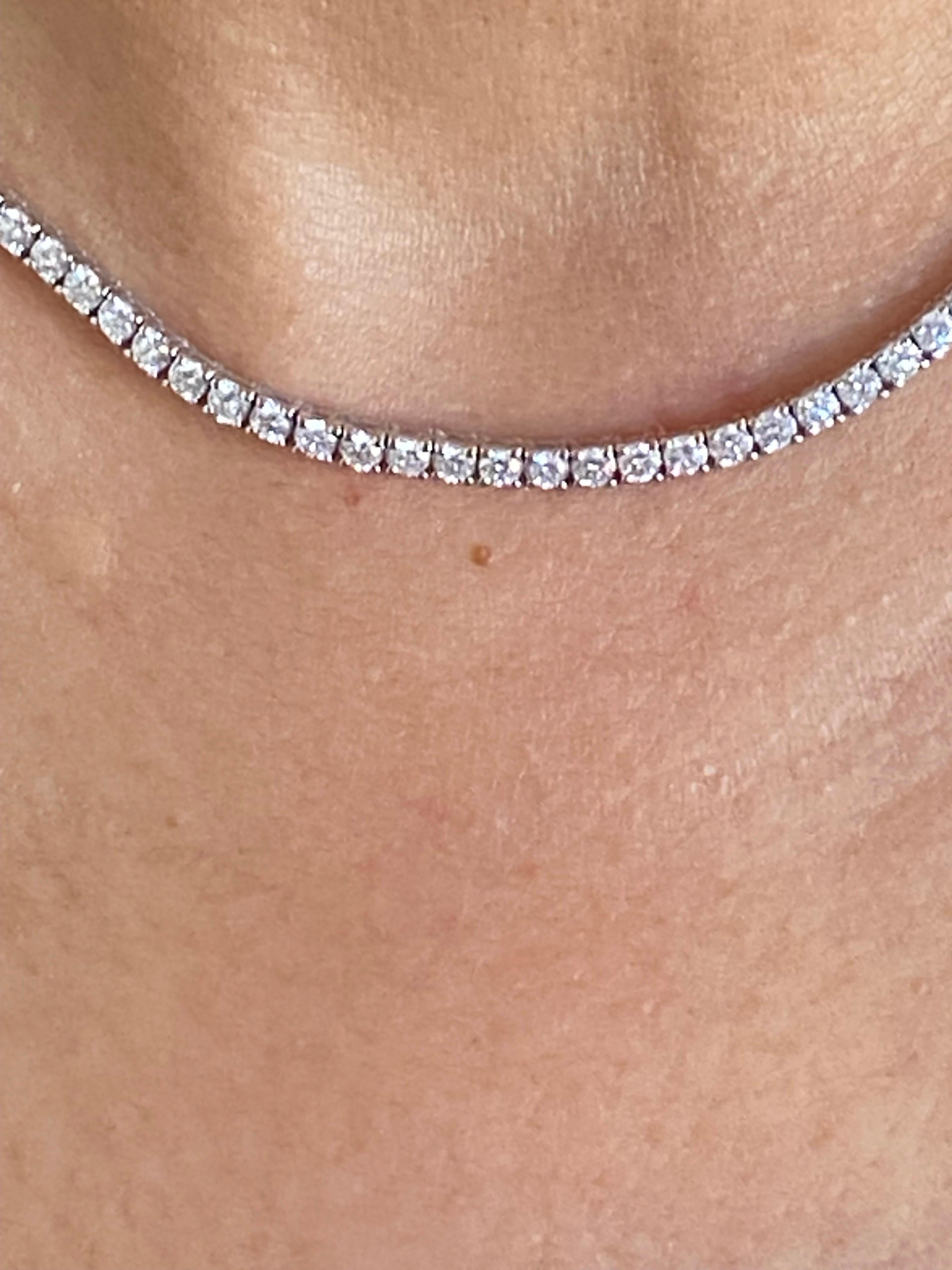 Diamond tennis necklace set with 0.10 carat stones each in 14K white gold. The total weight is 11.48 carats. The color of the stones are G, the clarity is SI1-SI2. The total length of the piece is 16 inches.