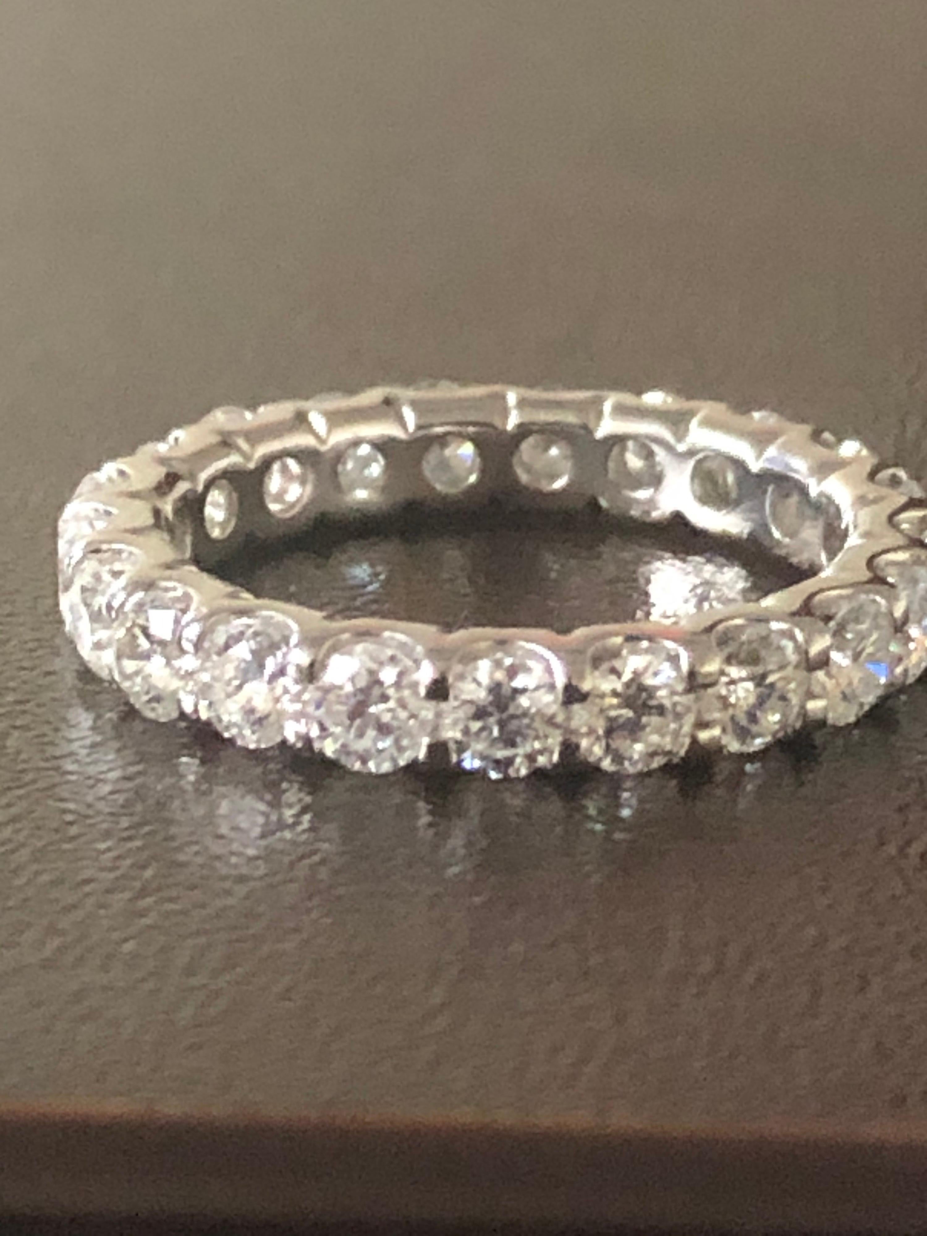 Diamond eternity ring set in 14K white gold. The stones are set in a u-prong low setting style. Each stone weighs 0.10 carat. The ring is set with 21 stones with the total carat weight of 2.10. The stones are G-H color and SI1-SI2 clarity. The ring