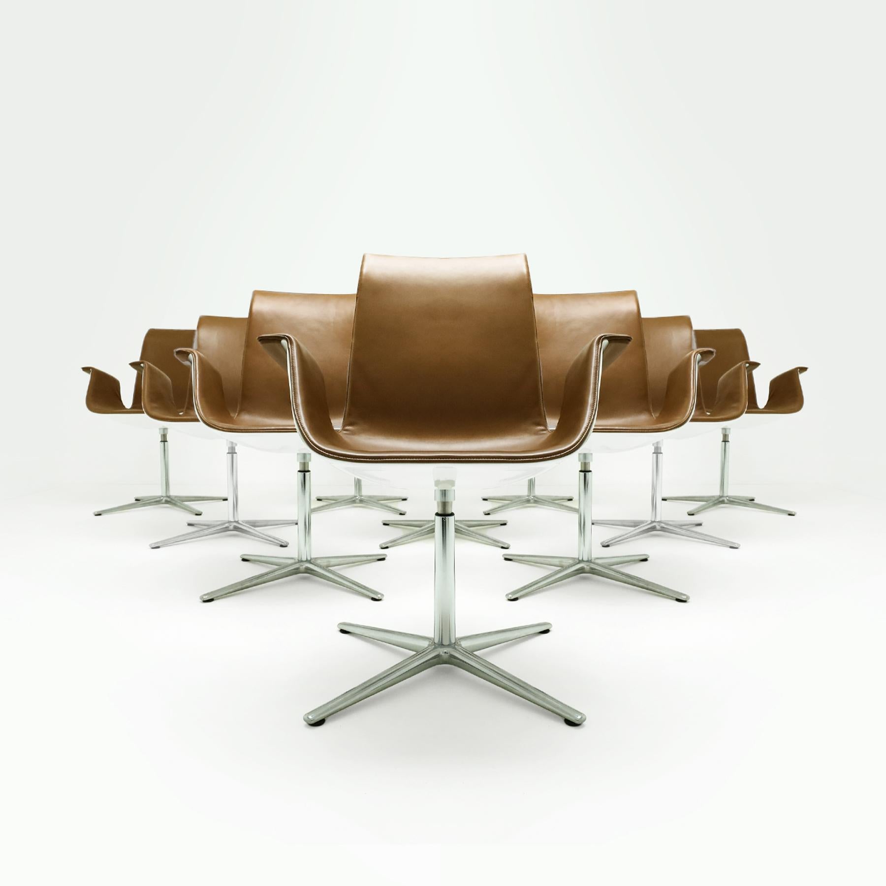 An exceptional limited edition set of 10 Danish Mid Century Preben Fabricius and Jørgen Kastlhom FK high back armchairs, model FK 6728-4G for Walter Knoll, in a cognac coloured leather with a white gloss shell and polished aluminium 4 star base. The