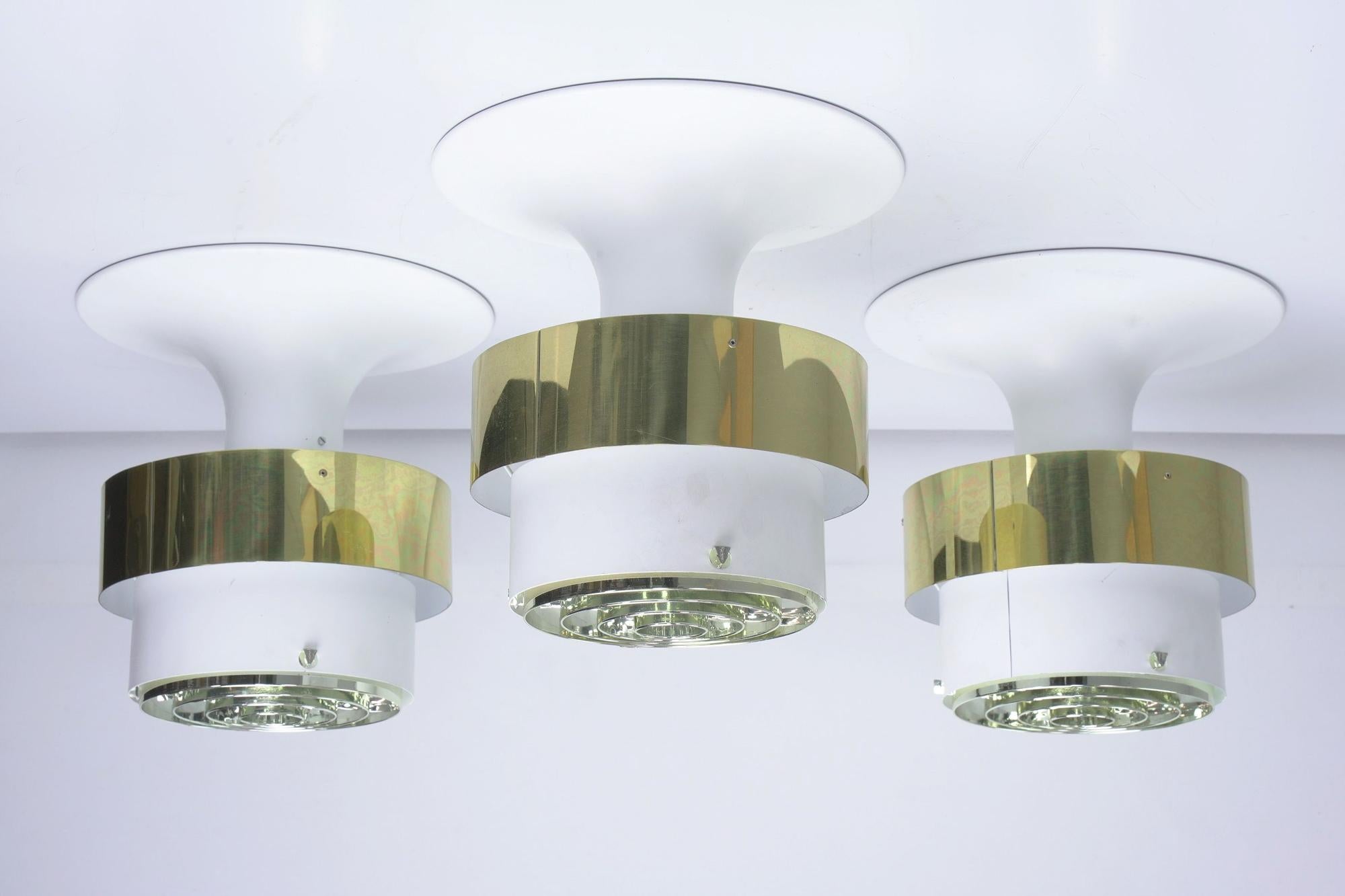 10 Scandinavian Modern Hans-Agne Jacobsson Markaryd lights. Ceiling light fixture T 771, eye-catching light by Swedish light master Hans-Agne Jakobsson. The top cone is attached directly to the ceiling and behind the golden metal band along the