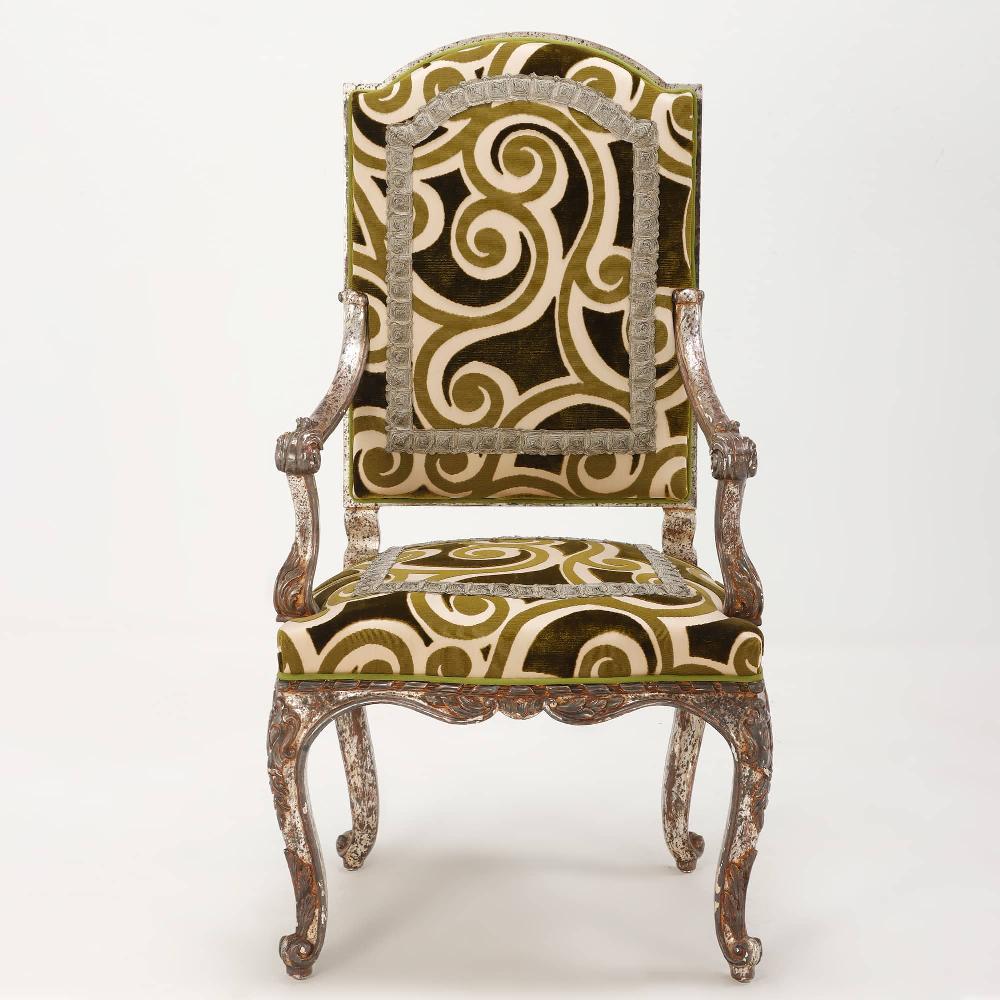 10 silver leaf open armchairs having hand carved frames and elaborate fabric treatment. The chairs do not appear to be very old, these were sourced in Paris and were sure to be a fortune when they were new. These are available and priced by the