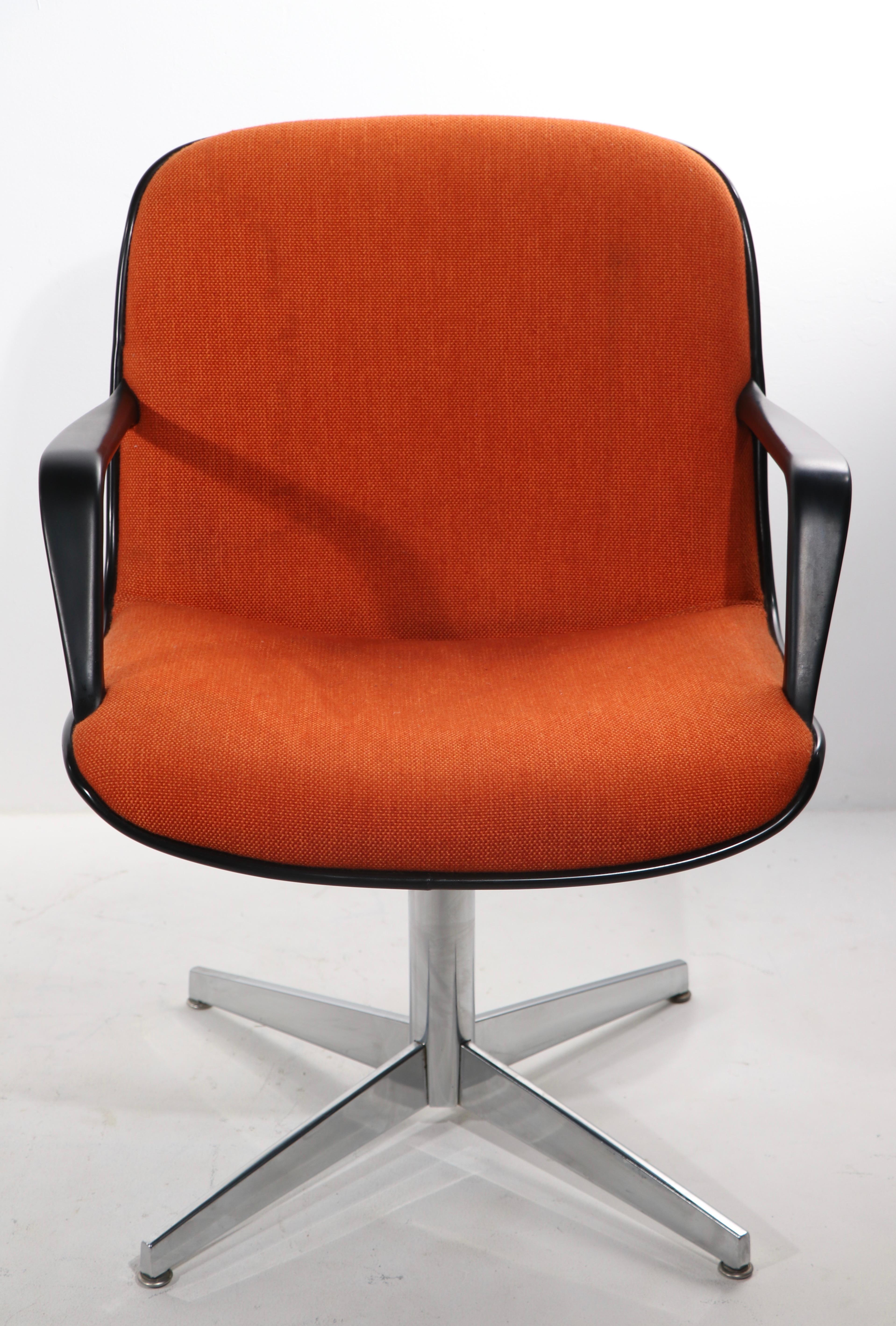 Nice lot of nine Steelcase armchairs, having a continuous test and back of orange tweed upholstery, dark gray plastic shell exterior, on bright chrome pedestal and four star base. The chairs are in very good, original condition, showing only light