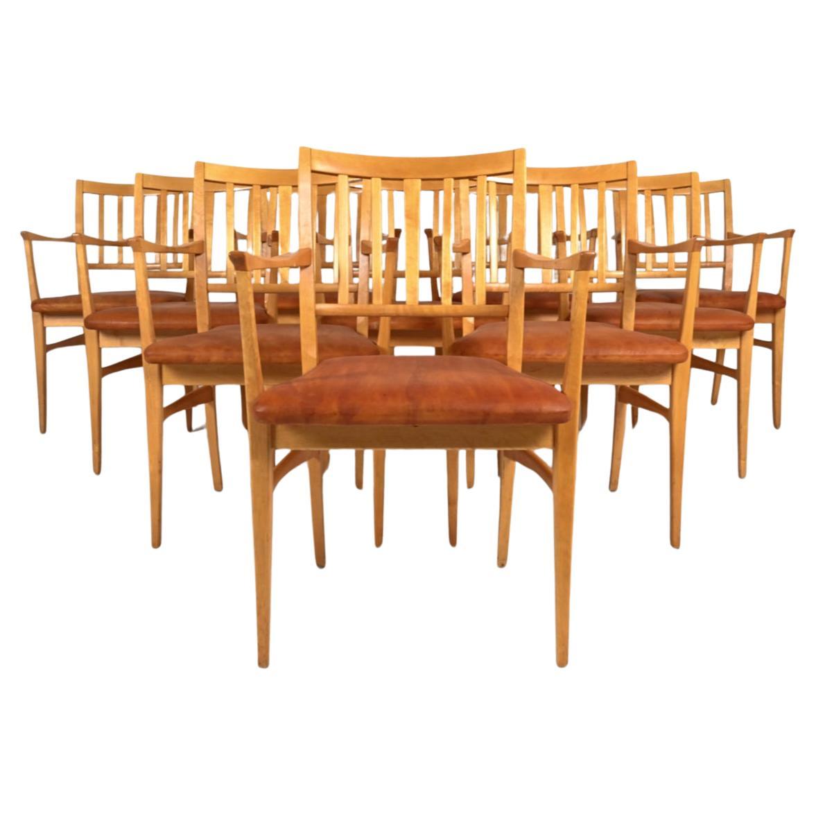 (10) Swedish Mid Century Modern slat back dining chairs designed by Carl Malmsten. Solid birch frames with leather upholstery that has a dyed finish. Very sturdy simple set of Swedish modern dining chairs. Sold as a set of ten chairs. Located in