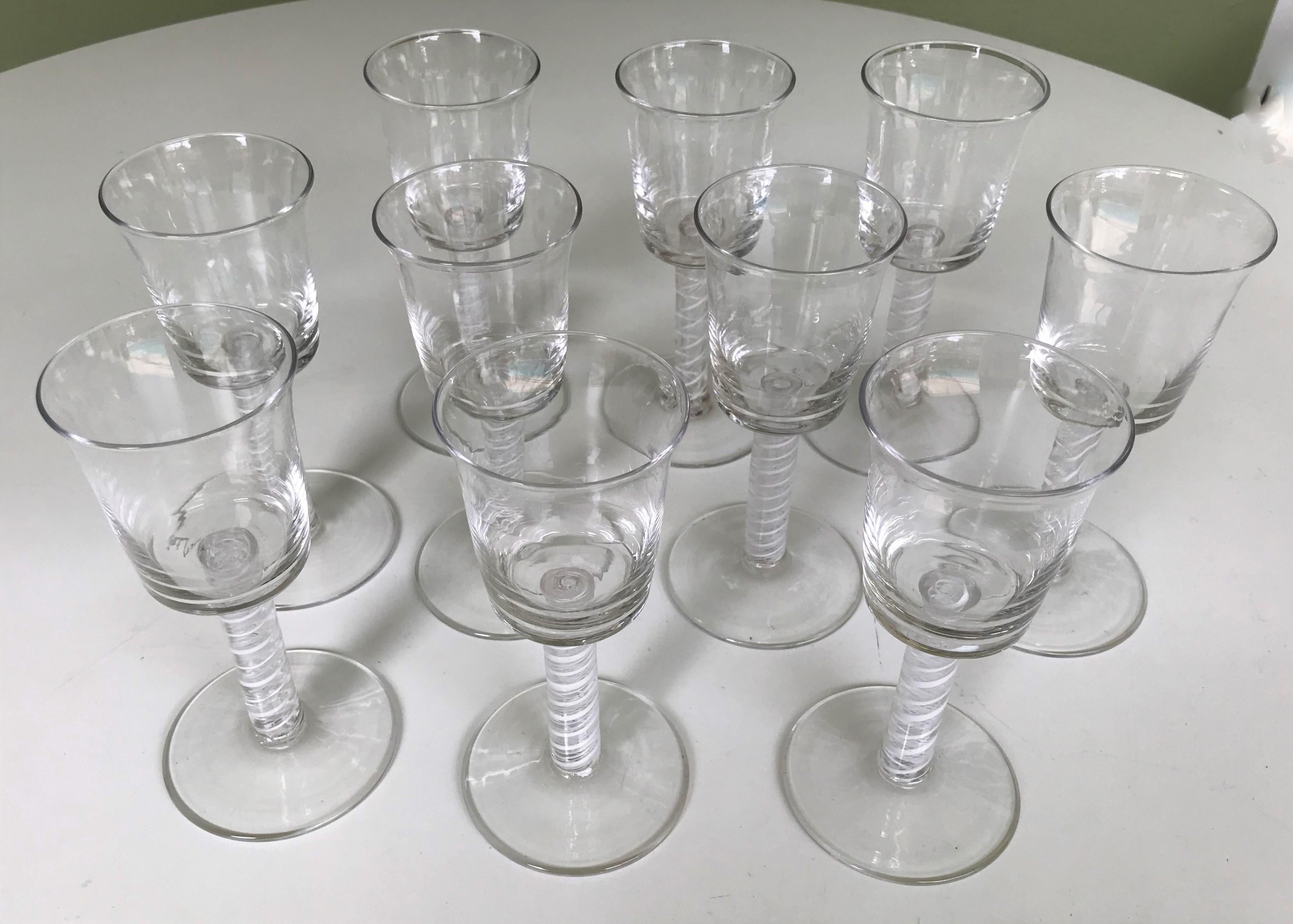 A set of ten goblets with exquisite white double twist Latticino stems. The beauty of the double spiral white in the clear stems is remarkable. Often referred to as opaque twist or air twist. Each blown glass holds 5 ounces. One goblet has a