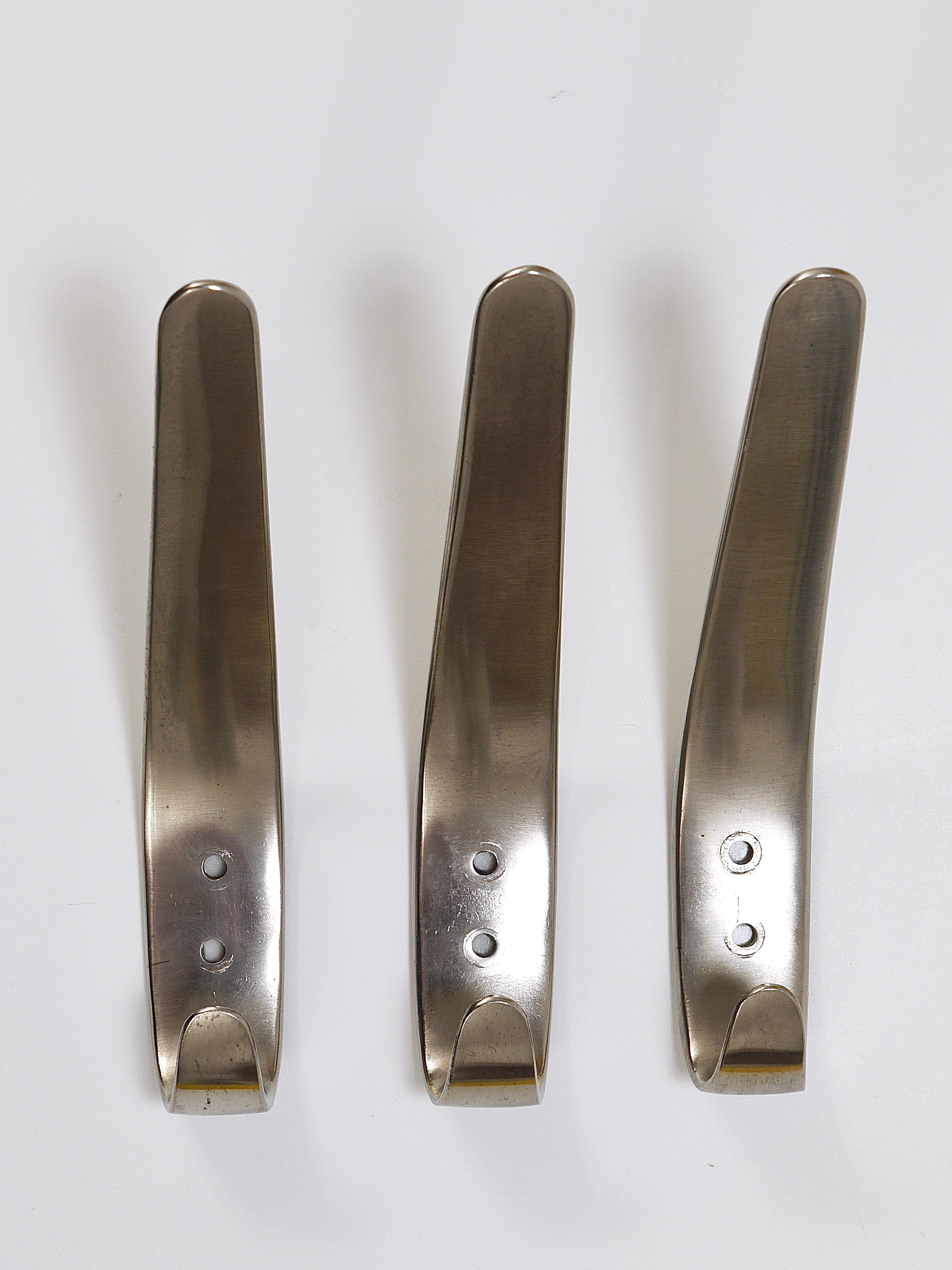 Up to 10 Midcentury brass wall hooks, model 4330, designed and executed in the 1950s by Carl Aubock II in Vienna, Austria. Sold and priced per piece. This is the more unusual nickel-plated version with its beautiful silver/nickel surface. These