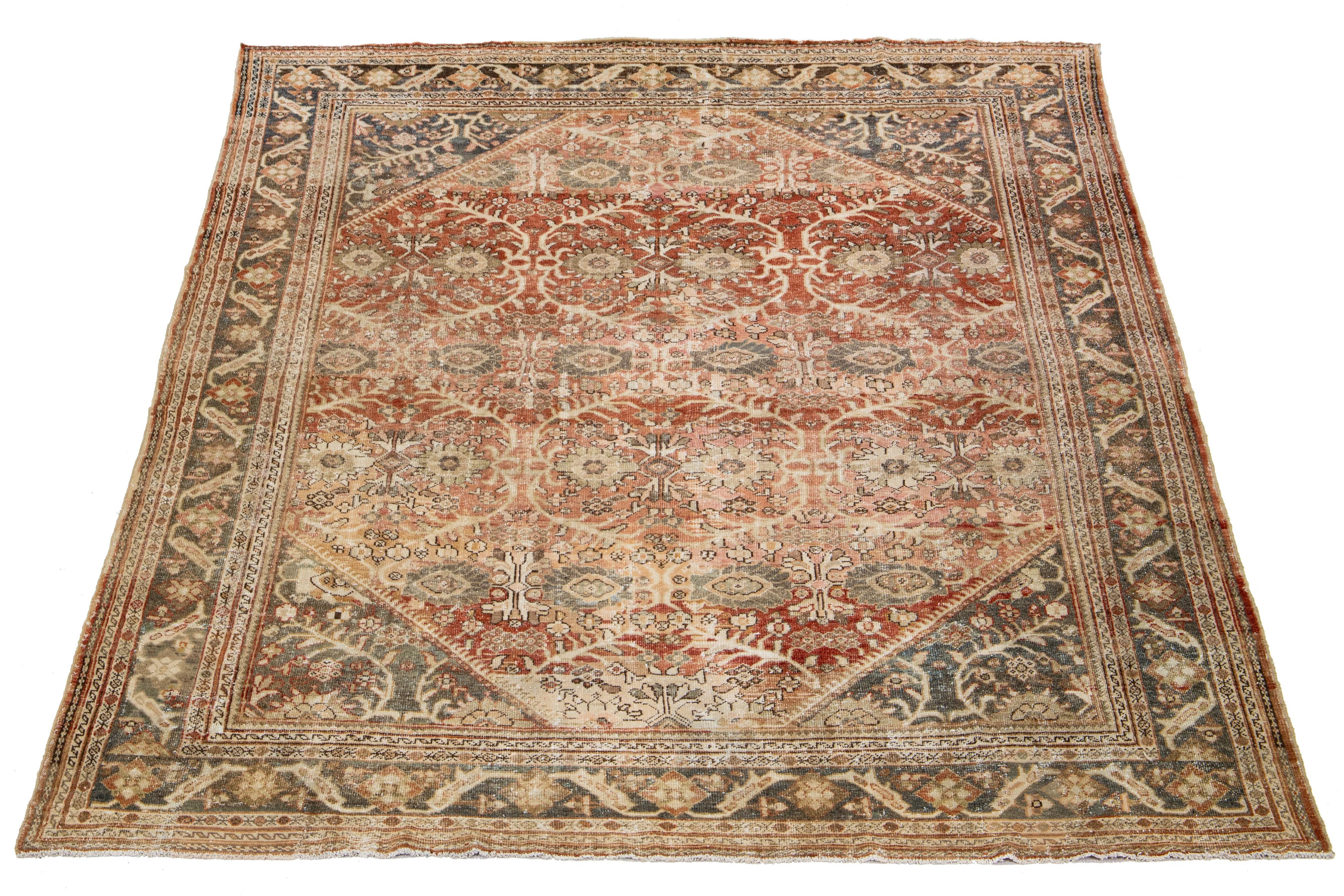 Hand-knotted wool Persian rug with rust field and floral motif in blue, pink, and brown hues.

This rug measures 9'10