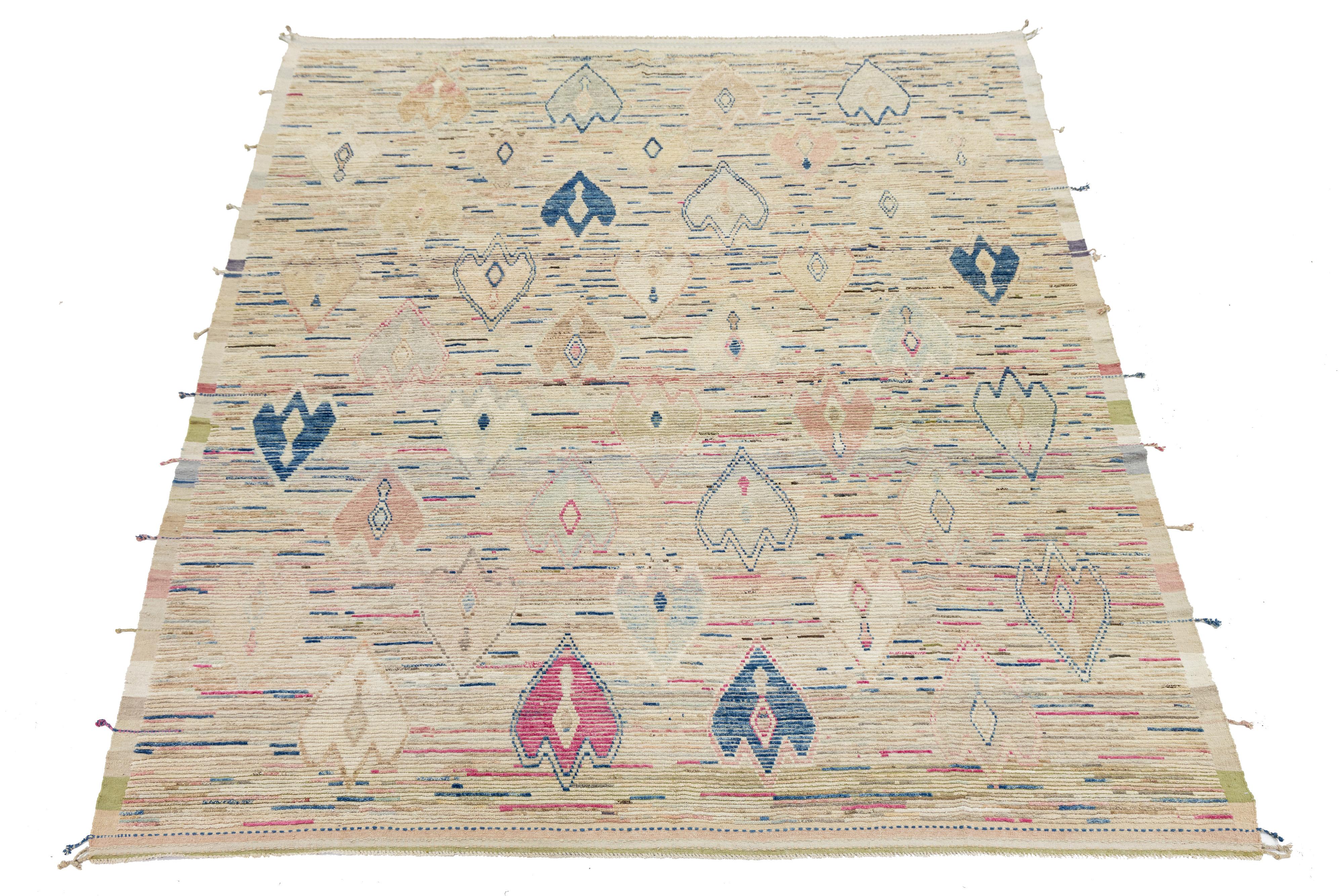 This exquisitely crafted wool rug highlights contemporary Moroccan design, set against a beige backdrop. The modern composition showcases a captivating mix of blue and pink, creating a striking visual effect that is sure to catch the eye.

This rug