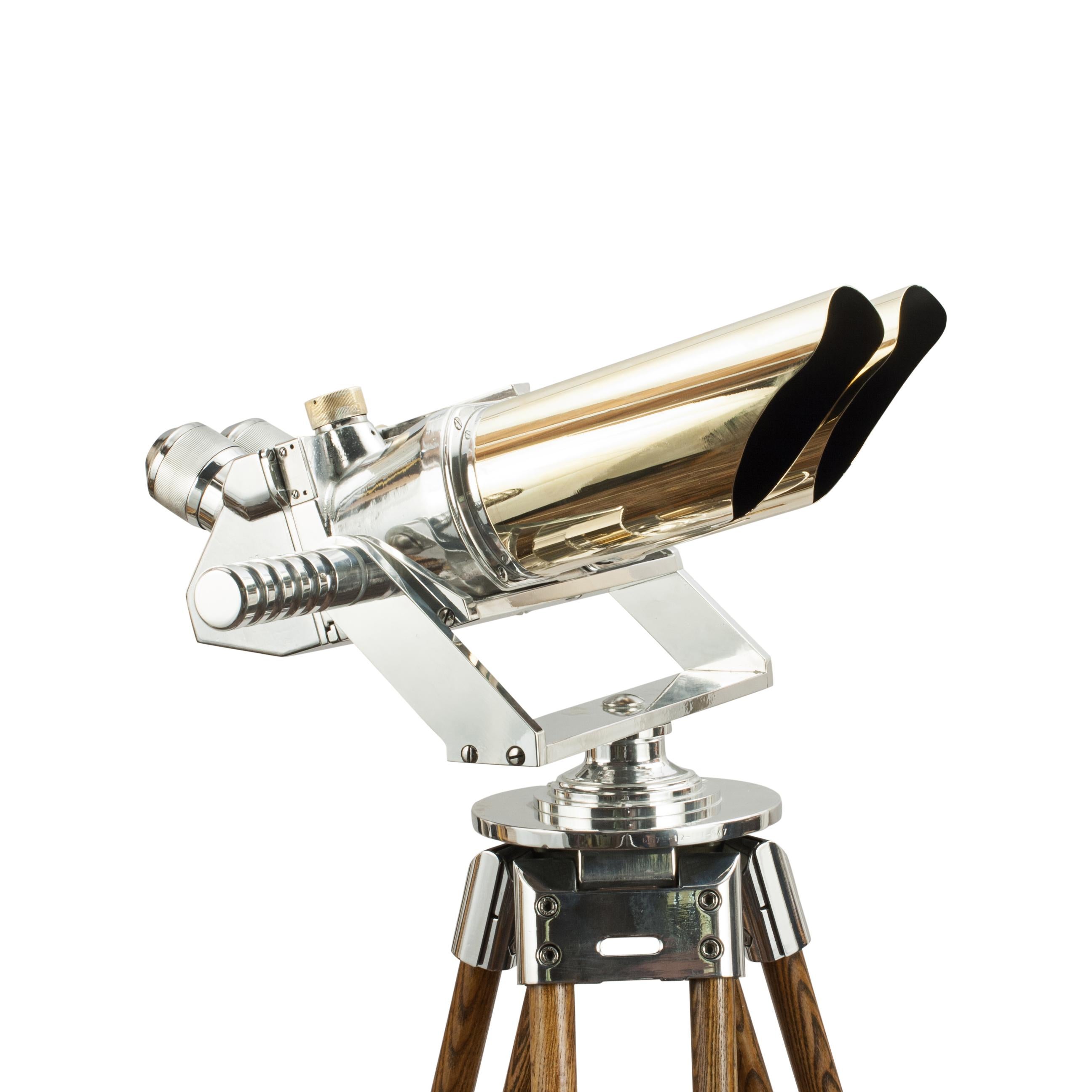 German Schneider Observation Binoculars, 10 X 80.
A pair of German ex-military observation binoculars mounted on a modern aluminium cradle and gimble with adjustable wooden tripod. The binoculars with 45º incline eyepieces and are marked D.F. 10 x