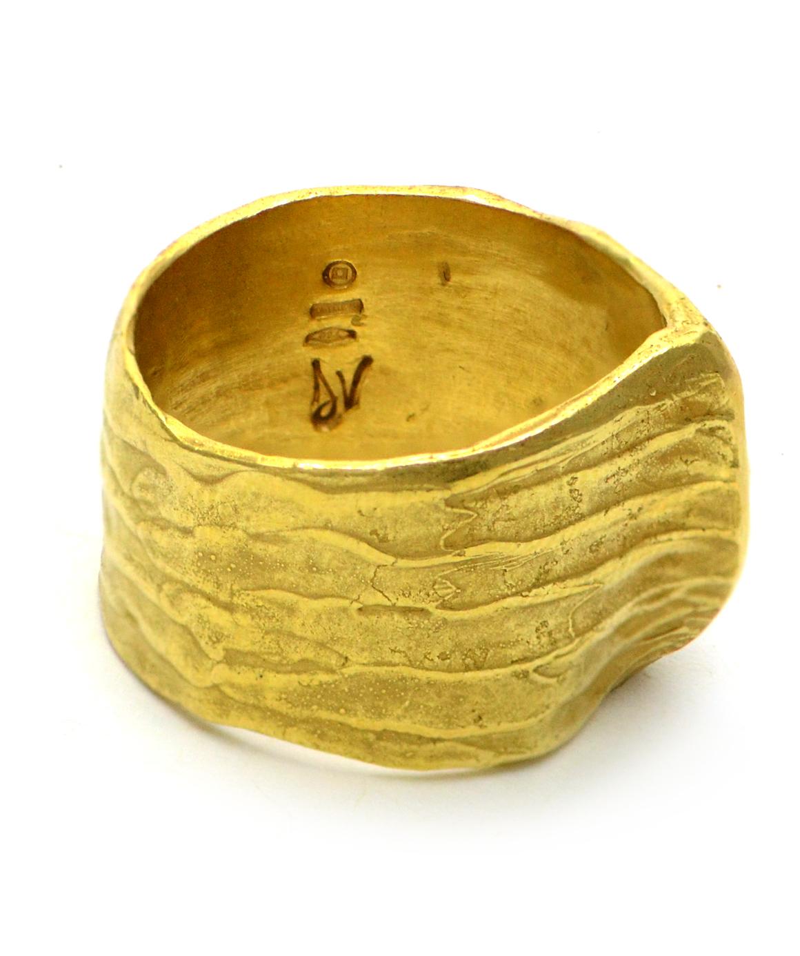 100% Authentic Daniela Vettori 18K Yellow Gold Textured Ring! 12.5 grams

This hand-forged texture with central pitched ridge. This stunning designer ring is made of 18 karat gold, and is a size 7. At its widest, the ring is about 17mm wide. 
Do not