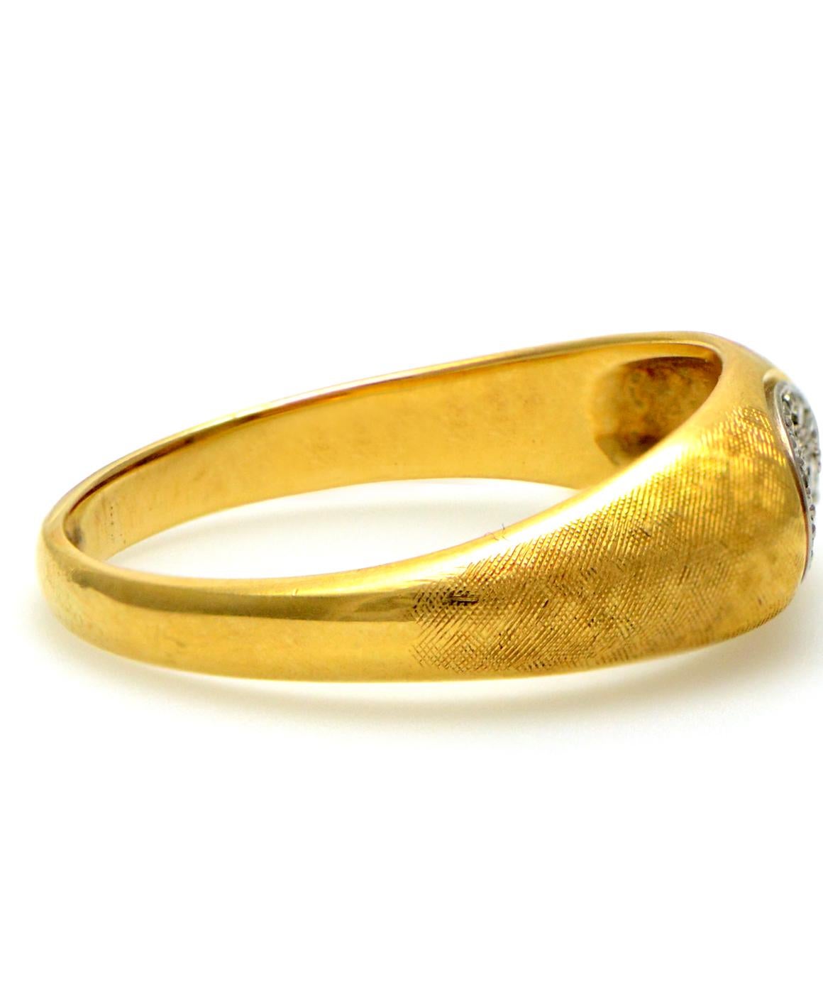 Excellent condition. This solid 18K yellow gold authentic Jabel ring has a textured finish on the top. There is a white gold plate in the middle of the ring consisting of 12 diamonds weighing 0.25cttw. The ring is a size 10 and weighs 6.2 grams.