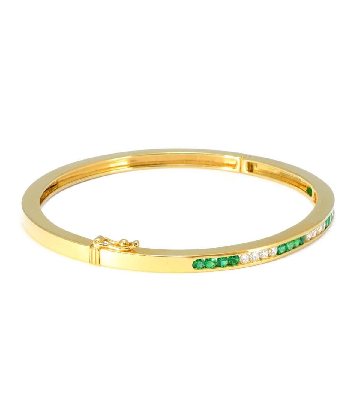 This 100% Authentic Tiffany & Co Solid 18K Yellow Gold Emerald & Diamond Bangle is in excellent condition! The inside of the bangle measures approximately 2.1 inches X 1.9 inches. There are 12 diamonds weighing approximately 0.36cttw & 16 emeralds.