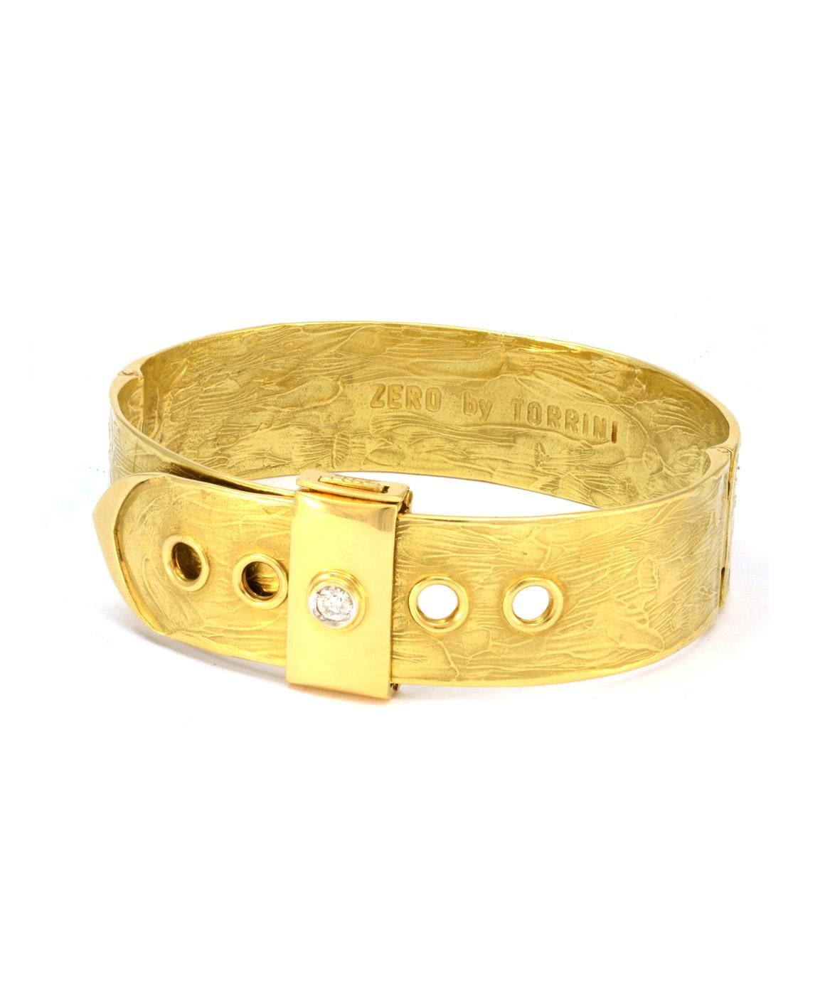 This 100% authentic Zero by Torrini diamond and solid 18k yellow gold bracelet is in excellent condition! With a belt style design, this bracelet can be clasped in multiple different spots allowing it to be adjustable. The textured design of the