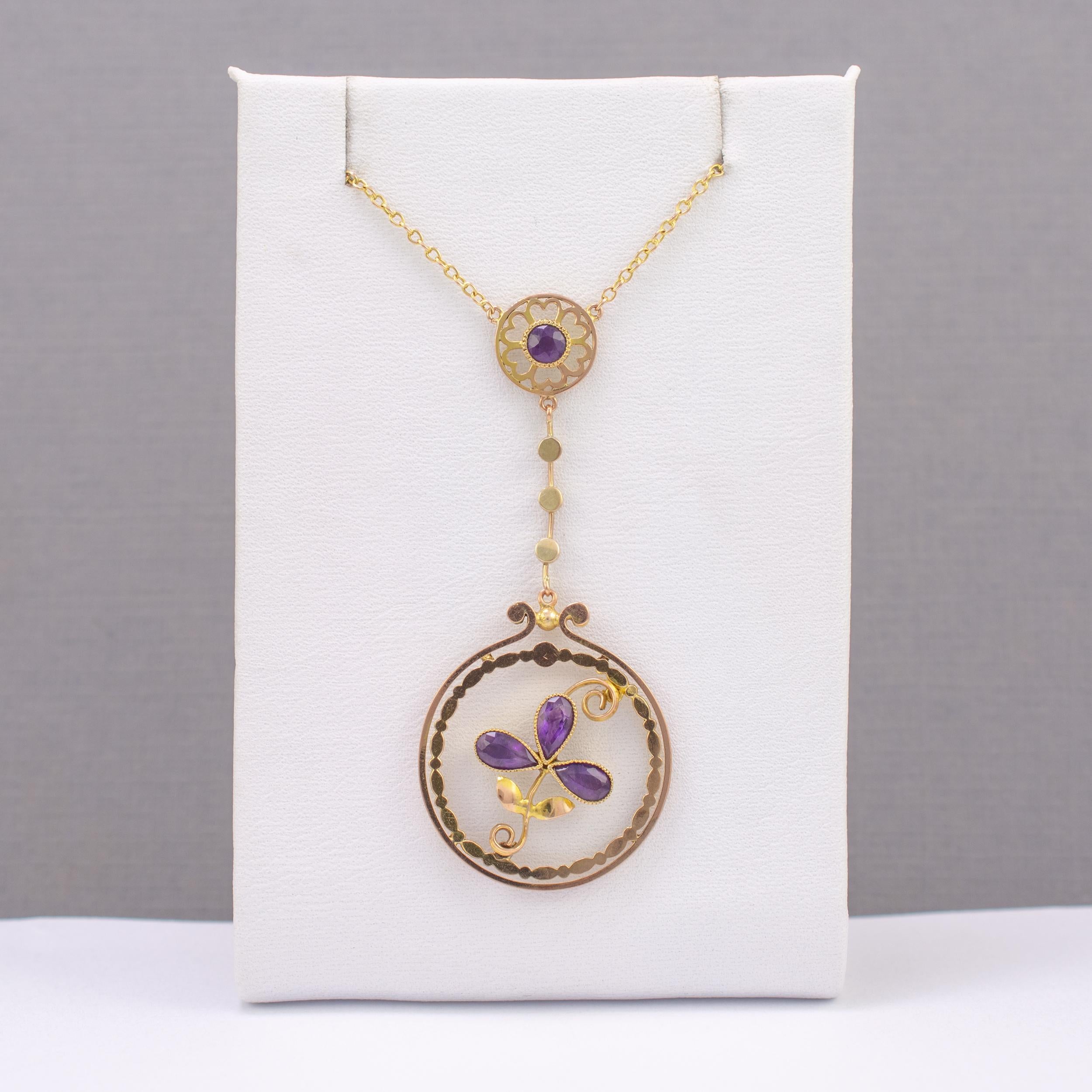 This exemplary amethyst shamrock pendant necklace is finely crafted and dates circa 1920s.

The large circle features 3 pear cut 0.25ct amethyst gemstones set in a shamrock arrangement that is suspended inside a double frame which has an inner