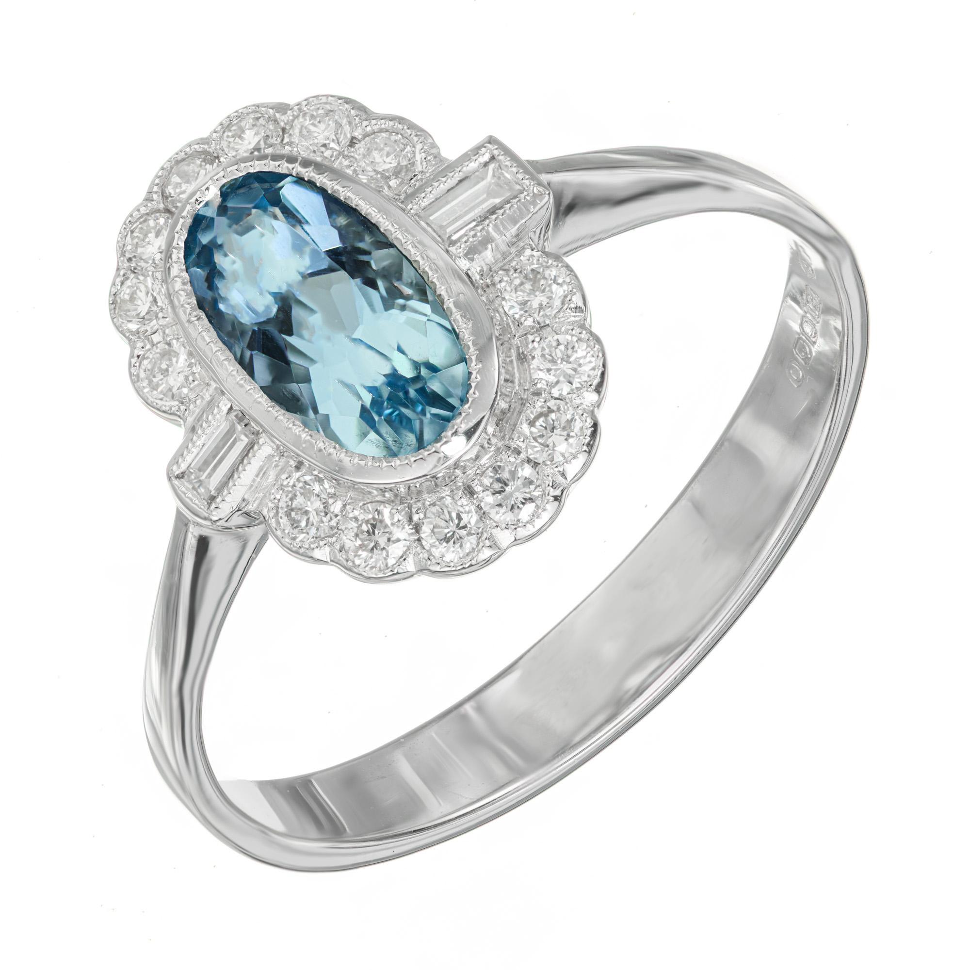 1950's Aqua and diamond ring. Oval aqua center stone with a halo of round diamonds with 2 baguette accent diamonds set in an 18k white gold setting. 

1 oval blue aquamarine, VS approx. 1.00ct
14 round diamonds, H-I VS SI approx. .17cts
2 straight